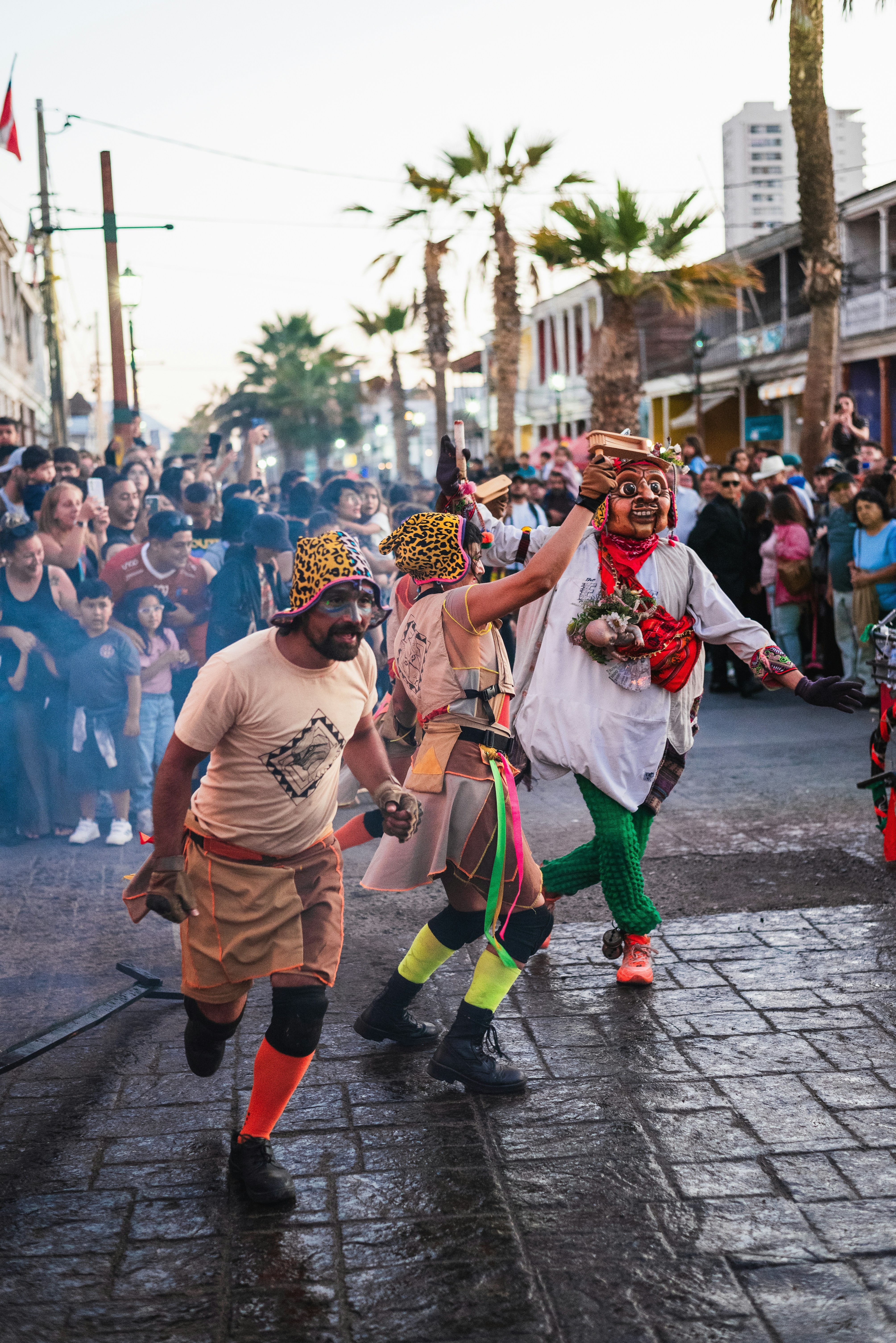A group of people walking down a street next to a crowd