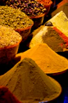 A bunch of different colored spices on a table