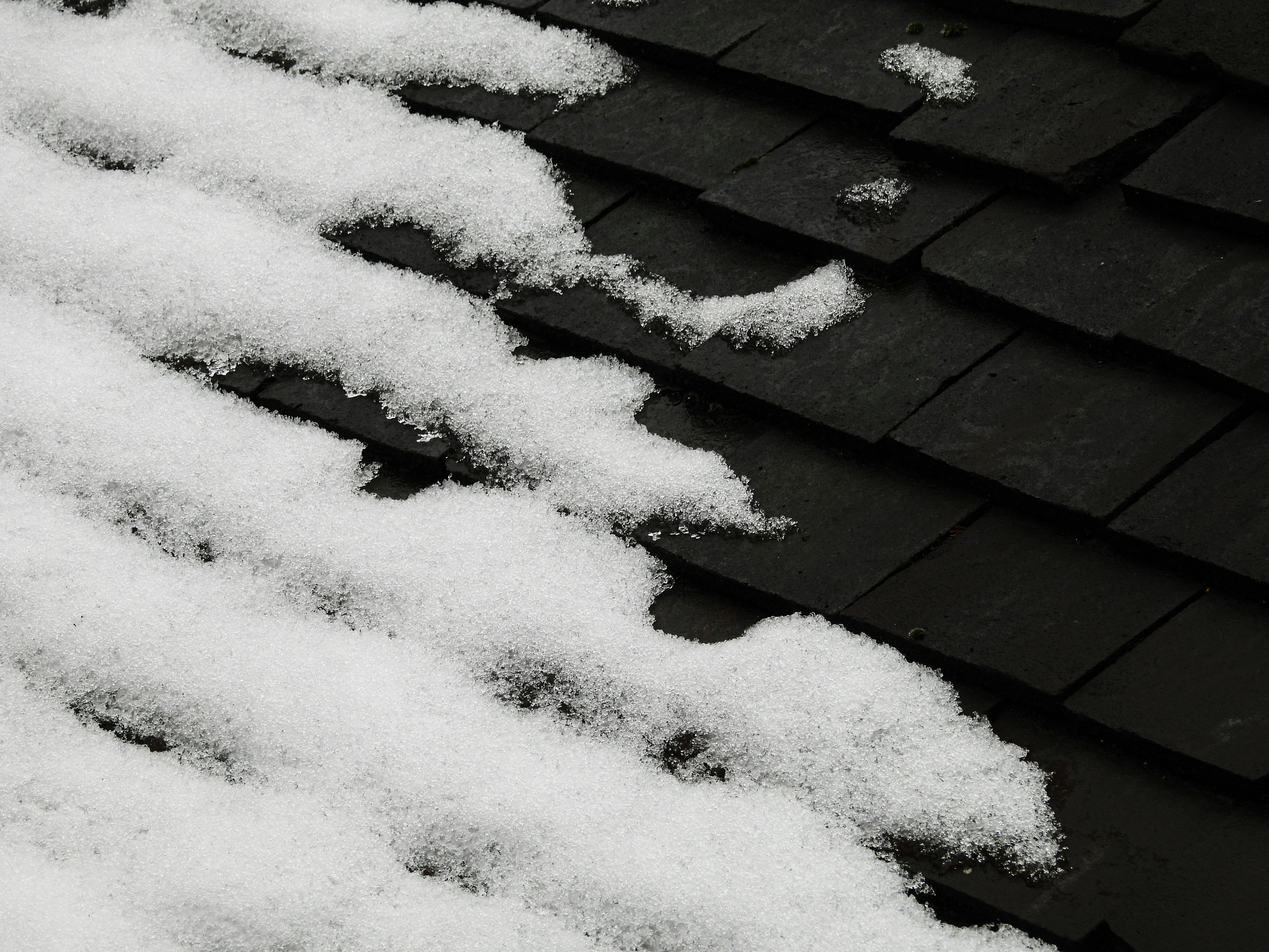 The roof of a house covered in snow