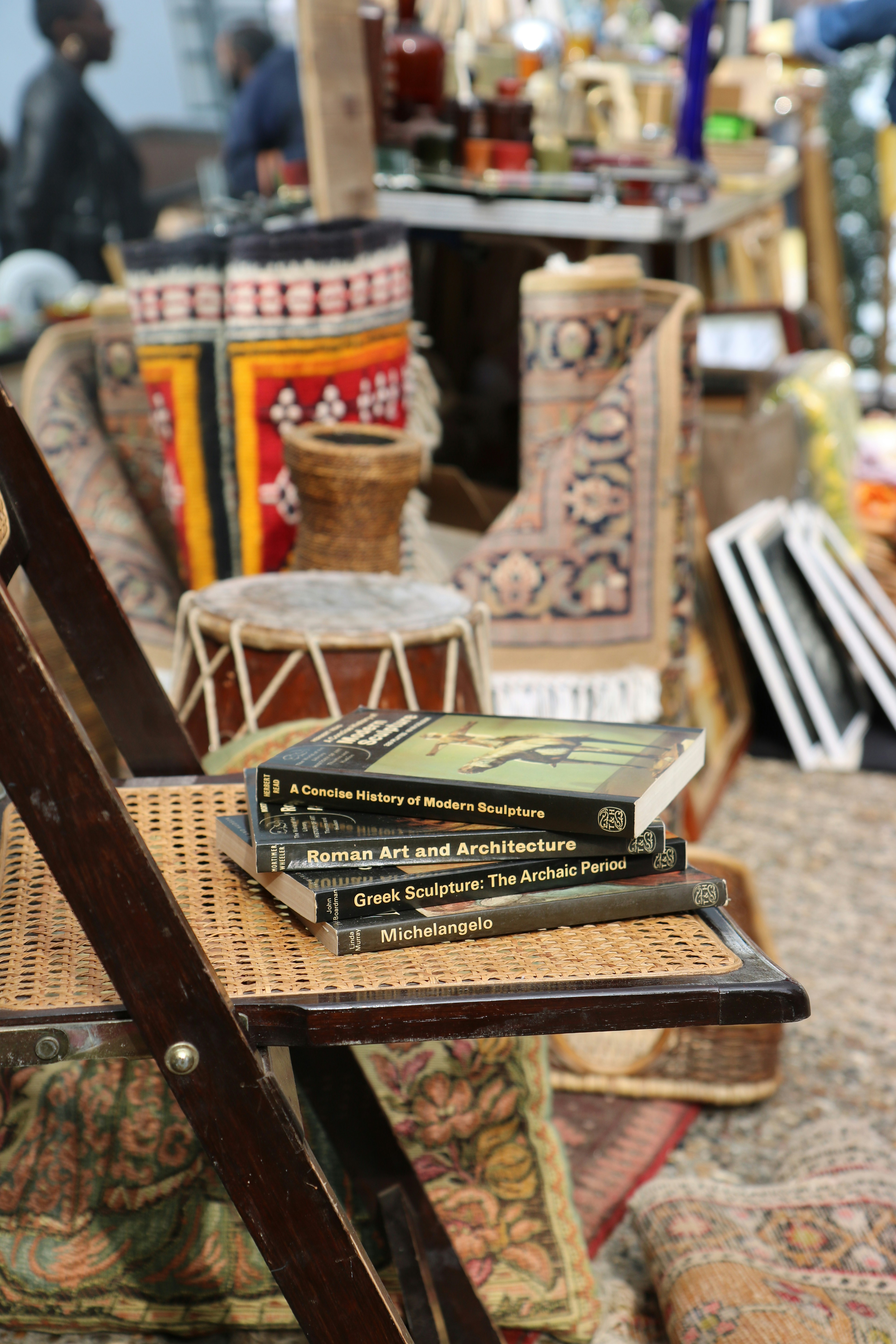A stack of books sitting on top of a wooden table