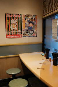 A long table with two stools in front of it