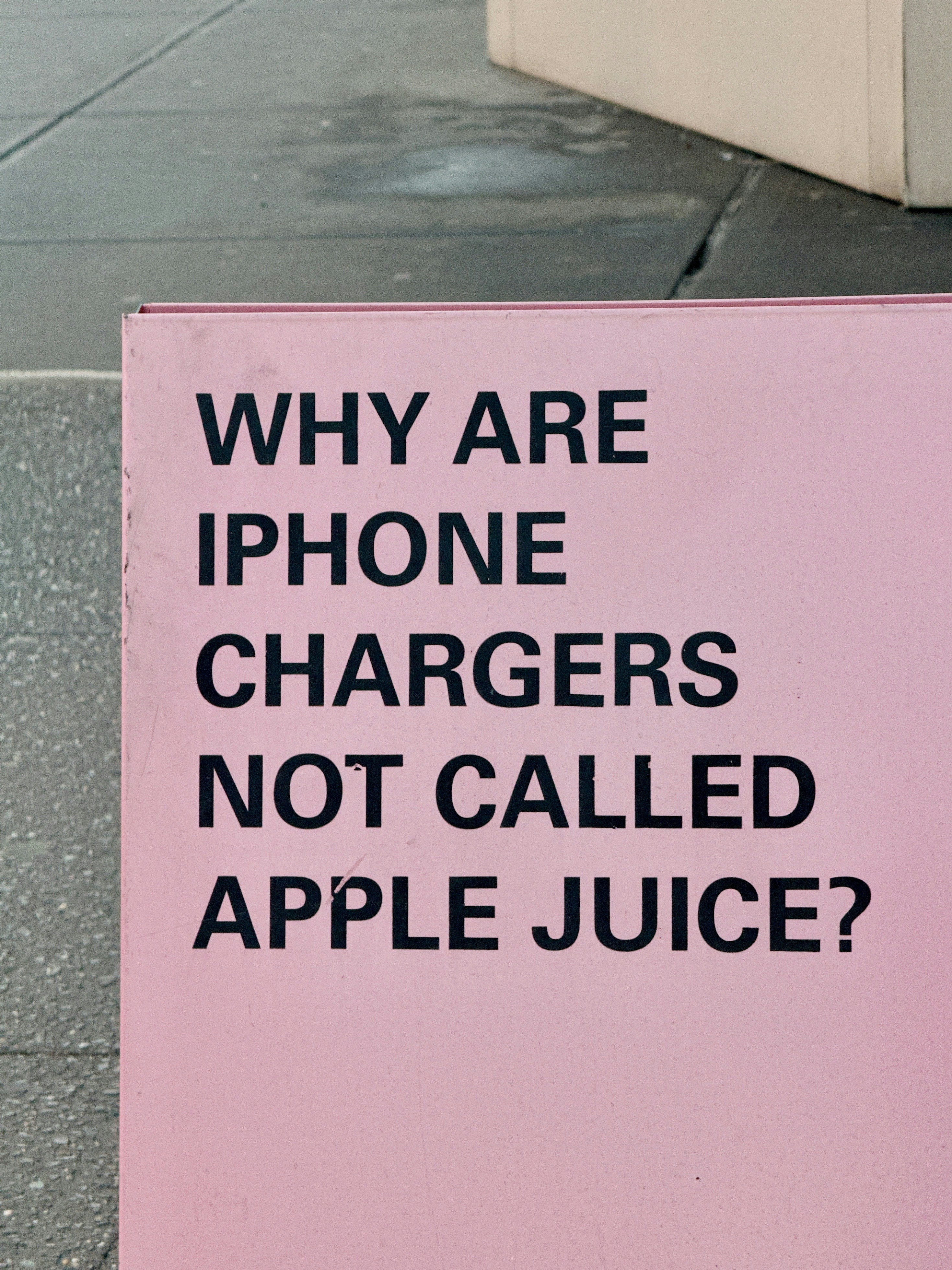 A pink sign on the side of the road