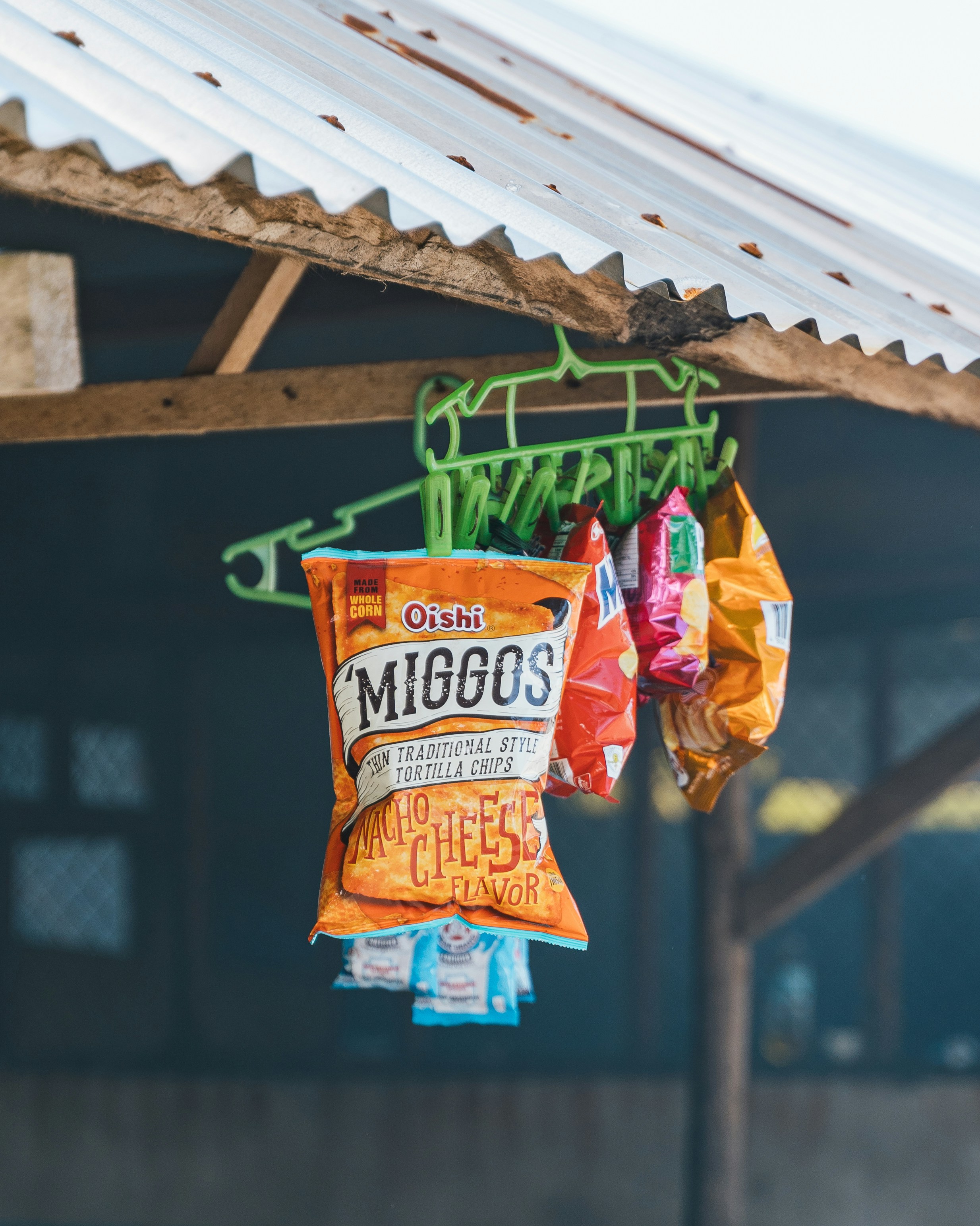 Bags of chips hanging from a wooden structure