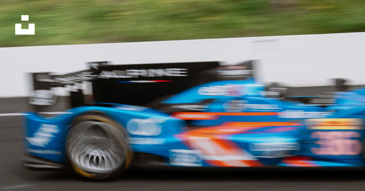 Race Trace Blue Raspberry A blue race car driving down a race track photo – Free Cars Image on ...