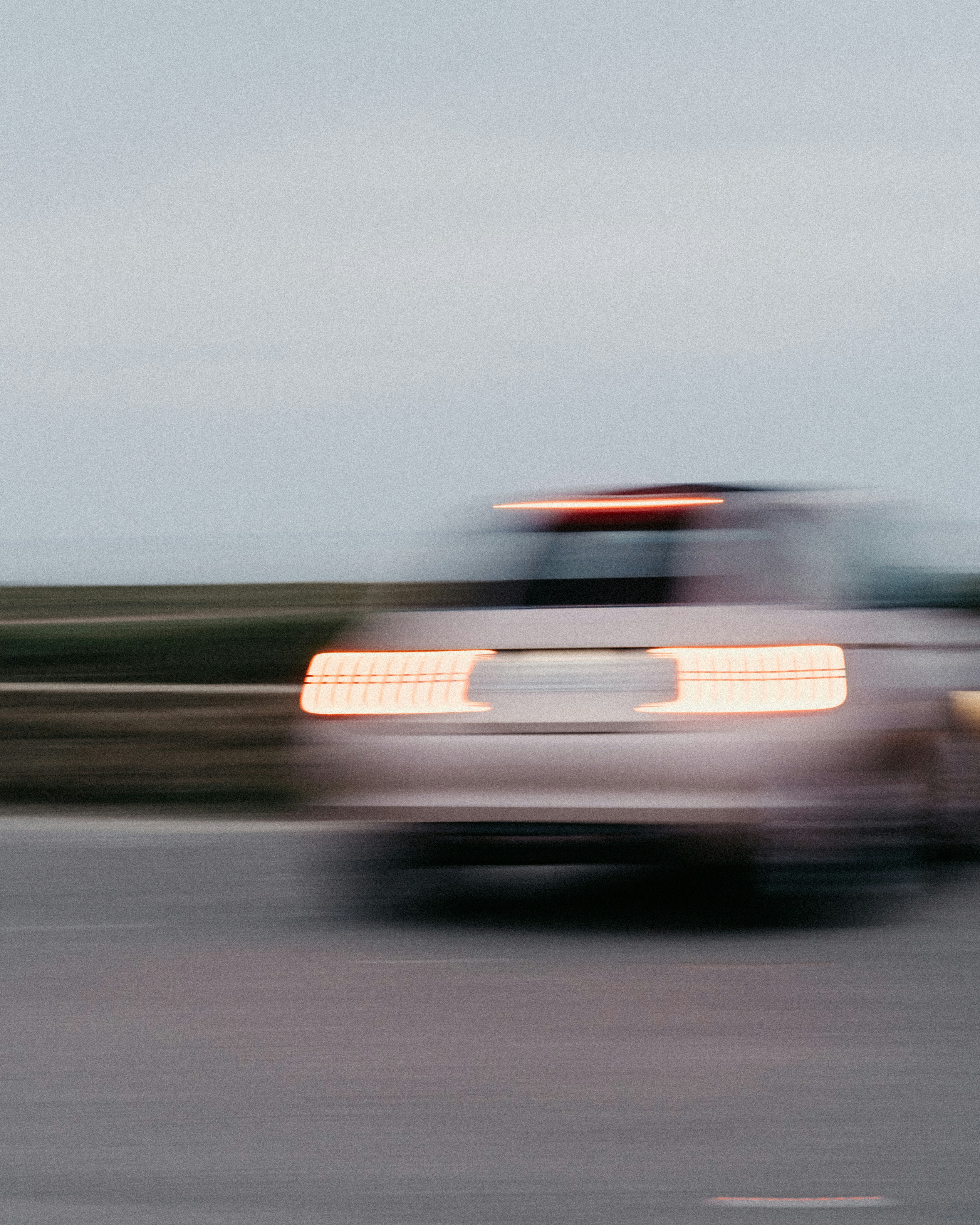 A blurry photo of a truck driving down the road