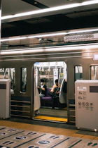 A subway car with people sitting in it