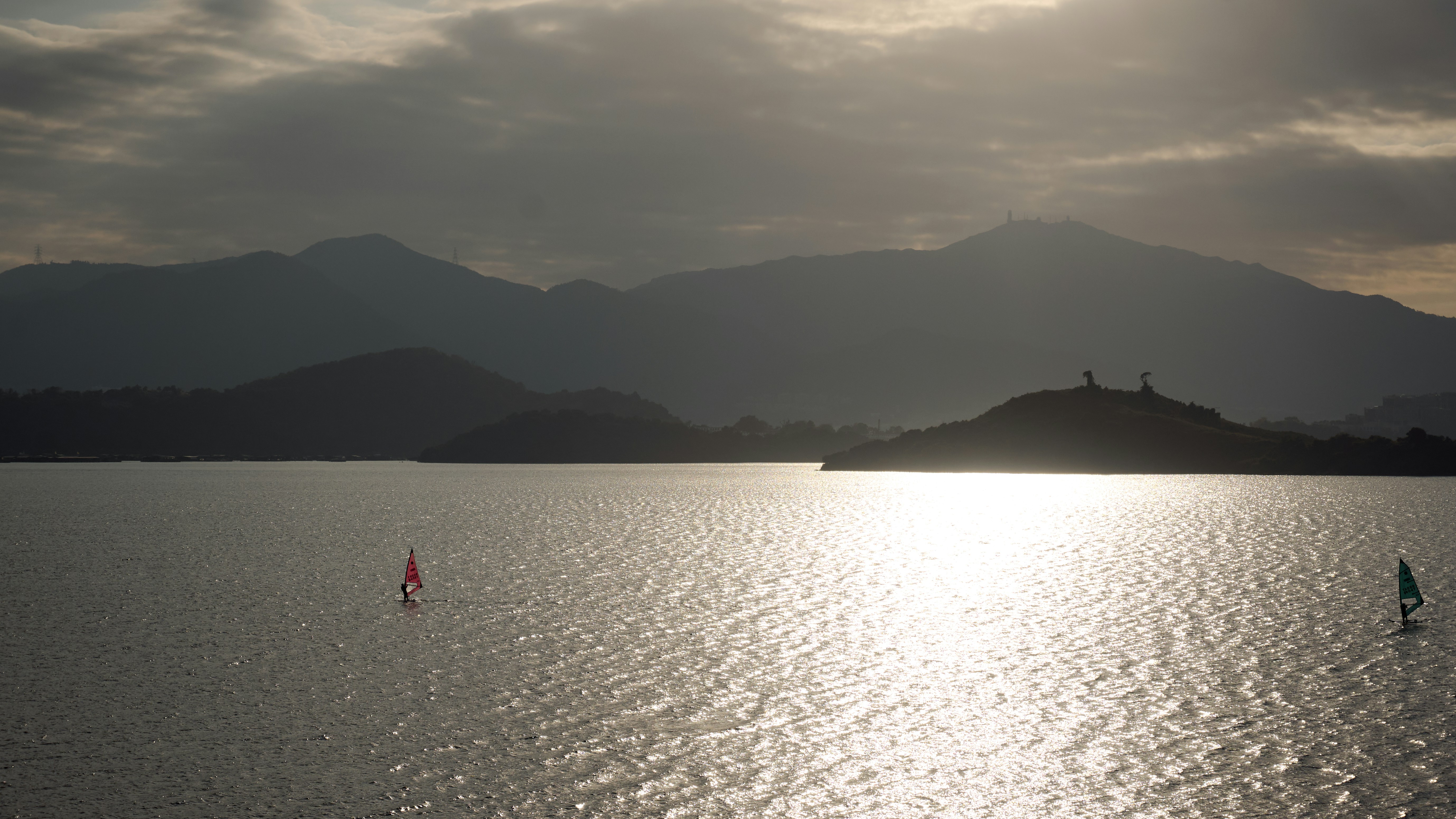 A large body of water with mountains in the background