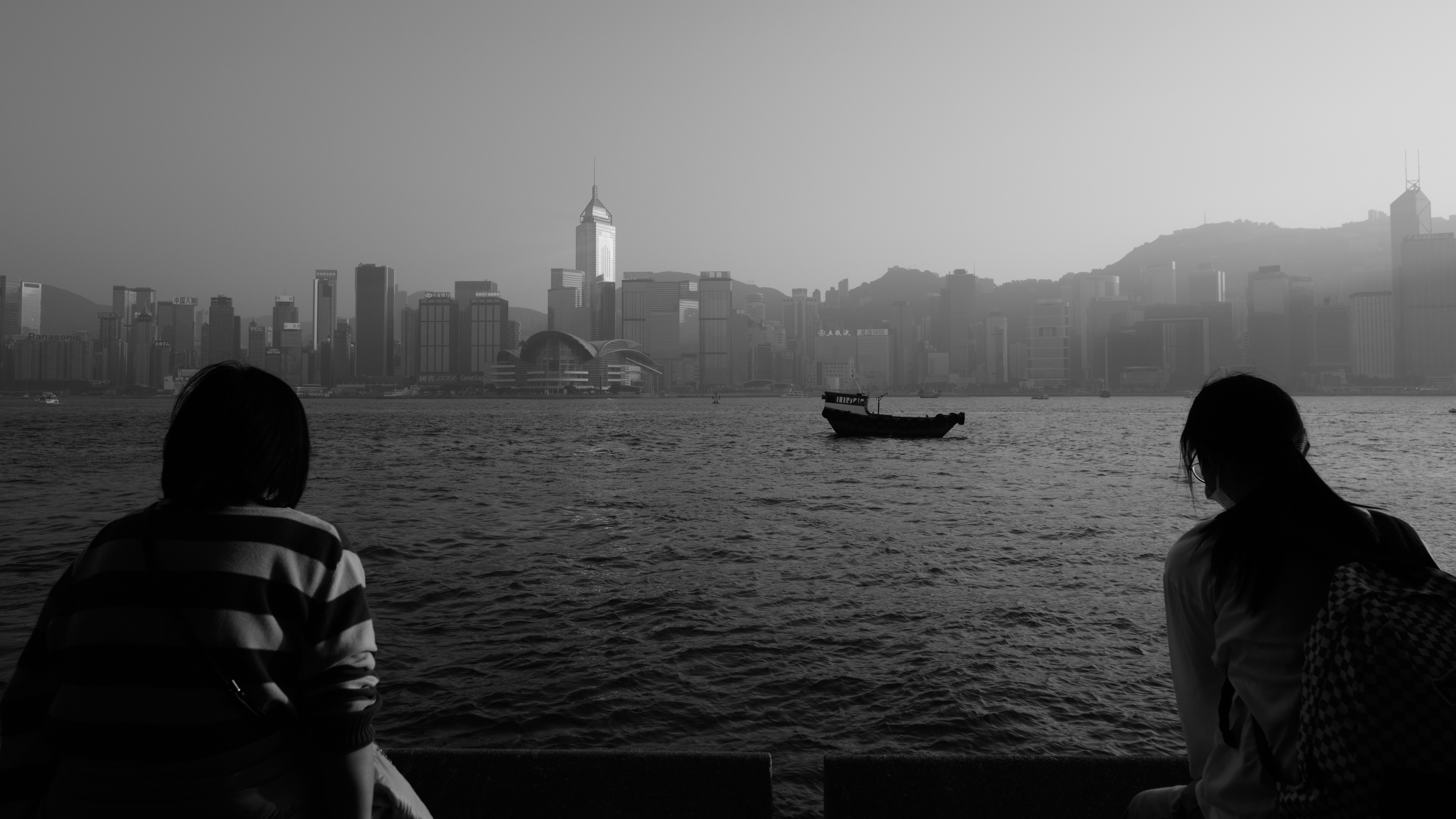 A couple of people that are sitting on a bench