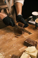 A person cutting up some food on a cutting board