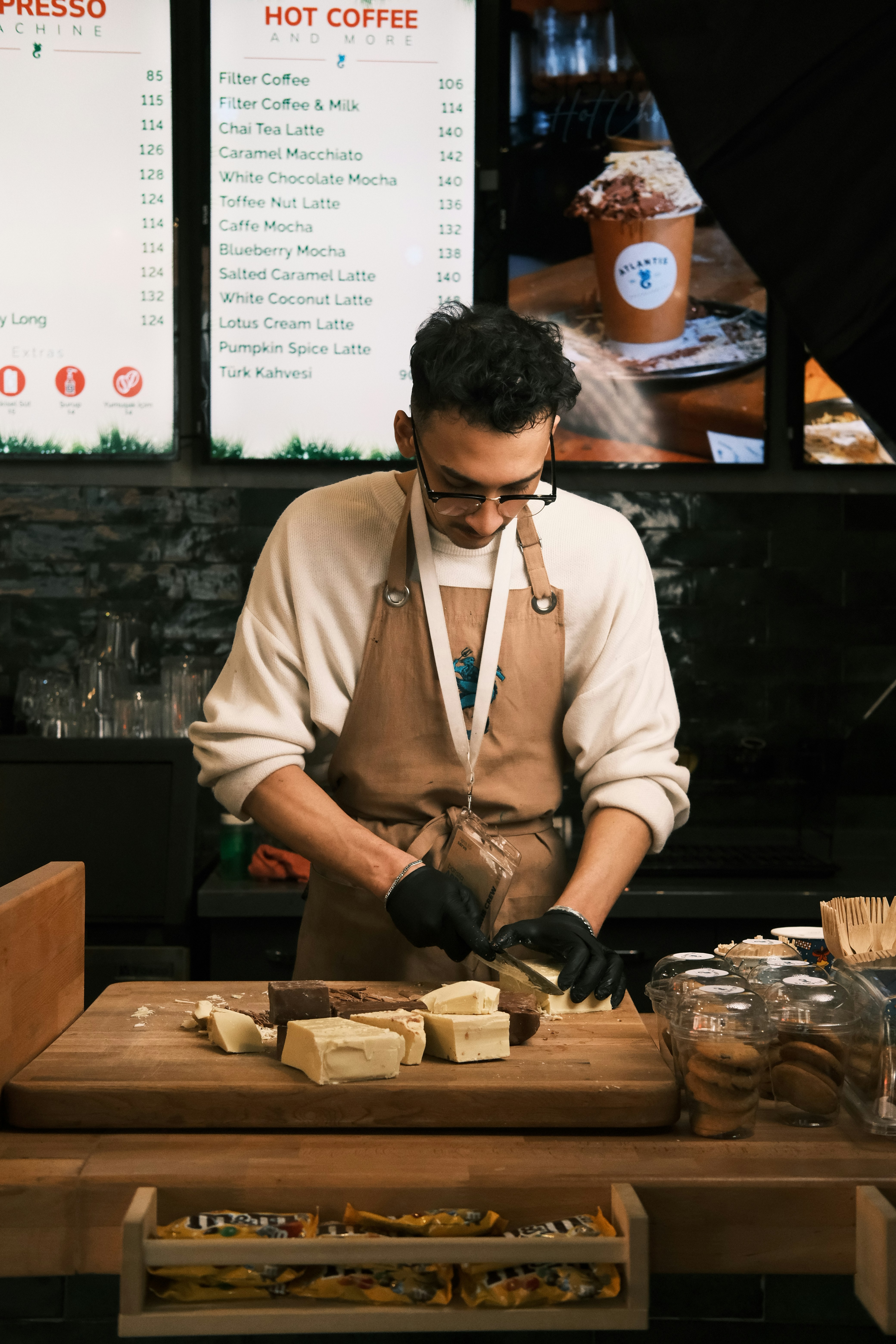 A man in an apron preparing food on a table