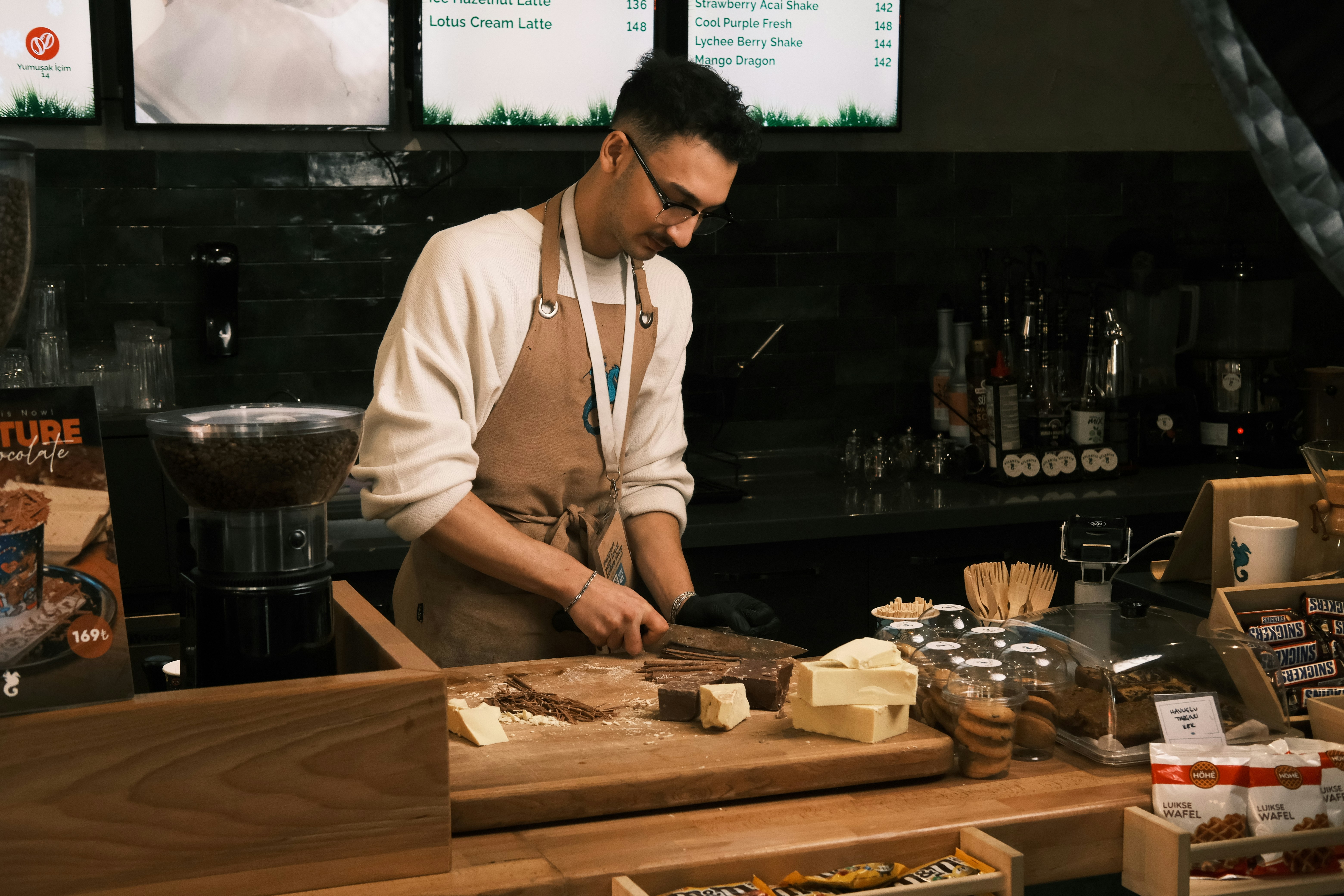 Worker preparing food at a deli counter