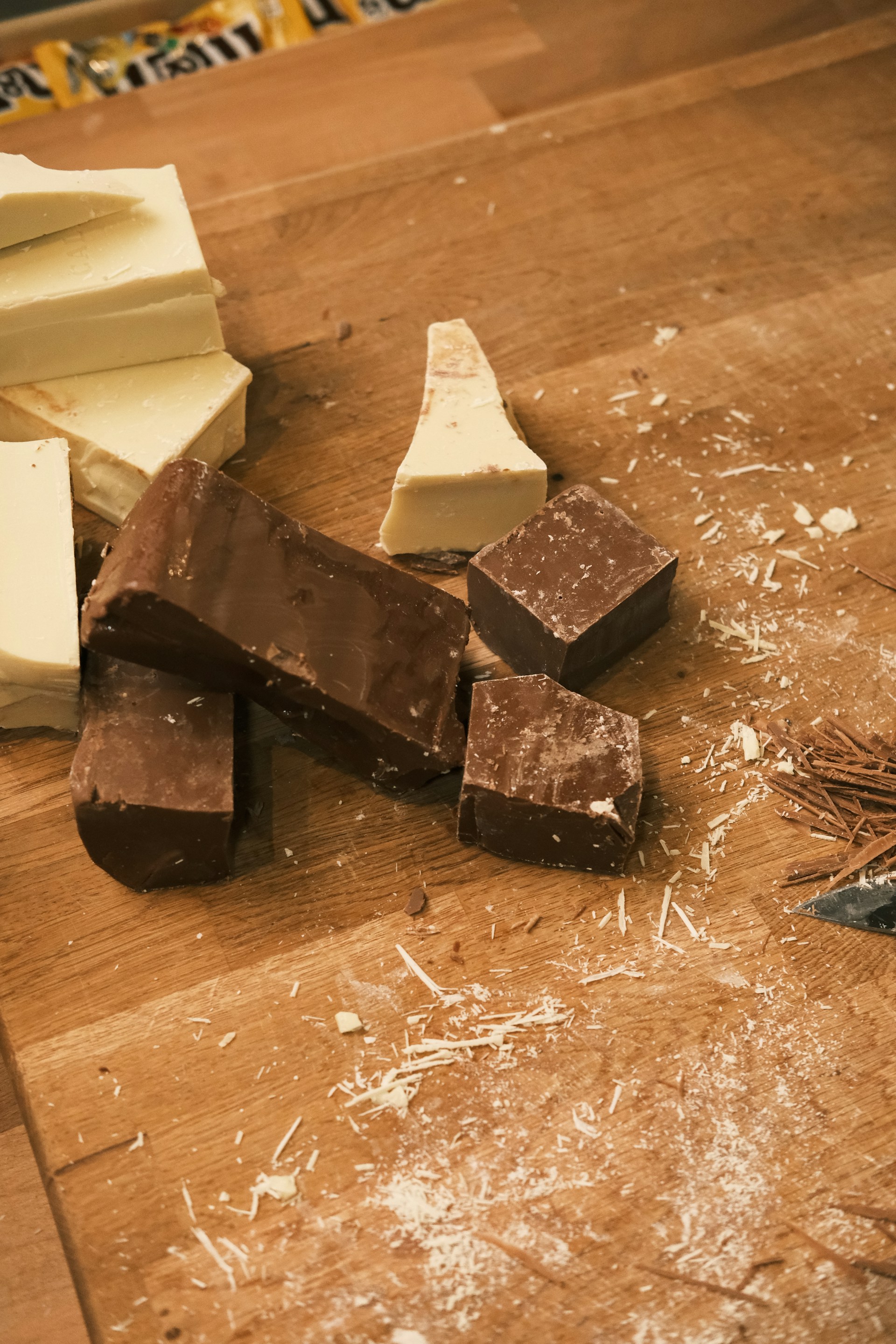 A wooden table topped with lots of different types of chocolate