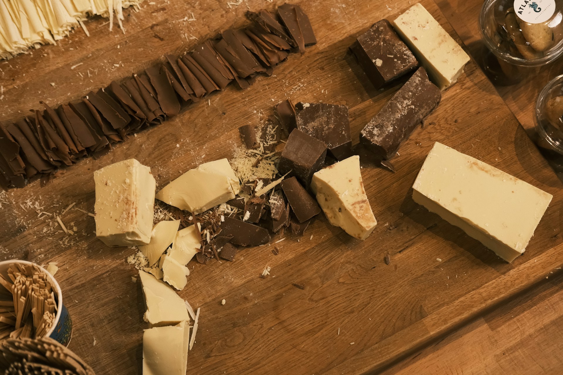 A wooden table topped with lots of different types of cheese