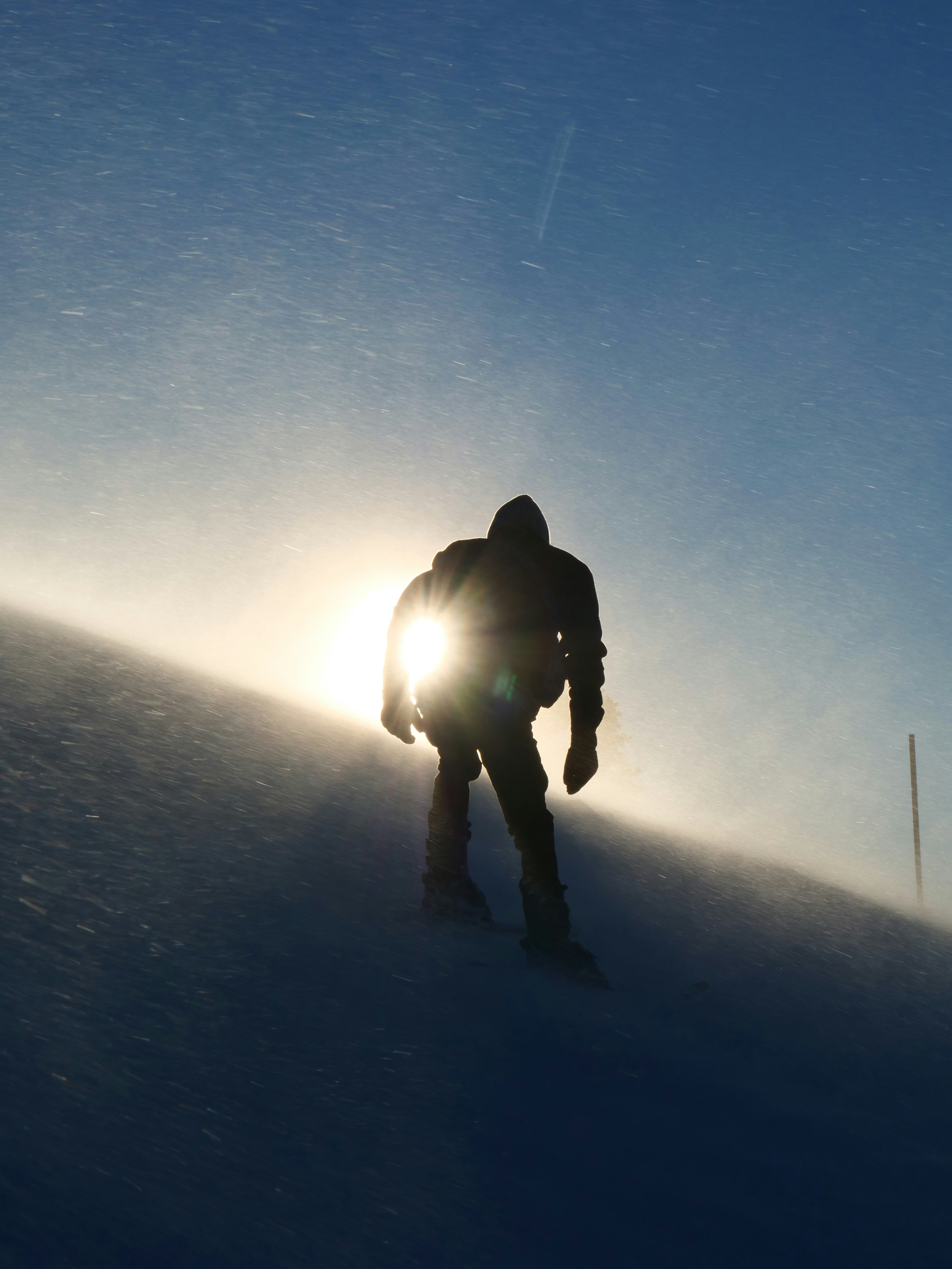 A person on a snowboard going down a hill