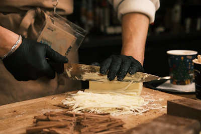 A person in a kitchen preparing food on a cutting board