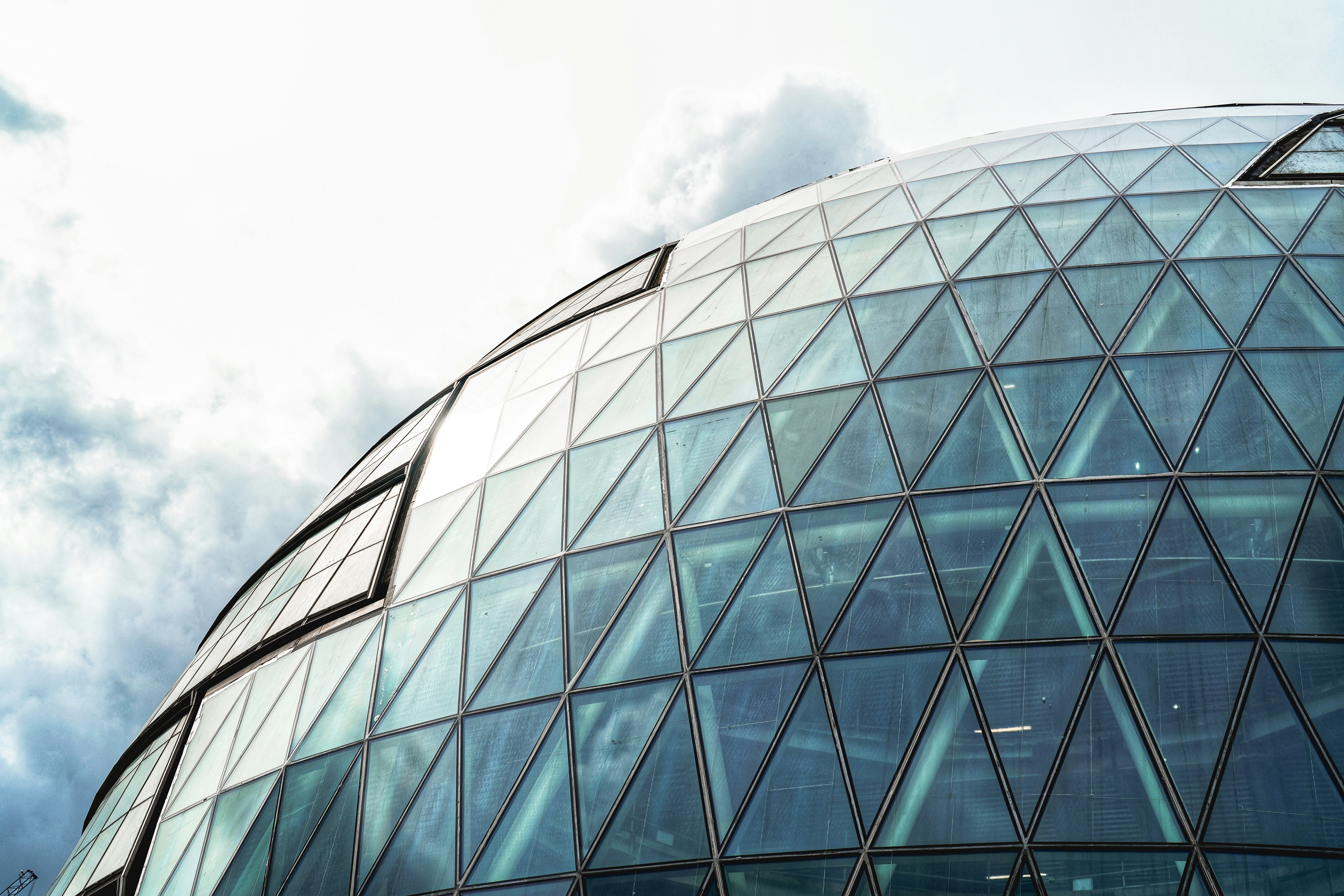 A large glass building with a sky background