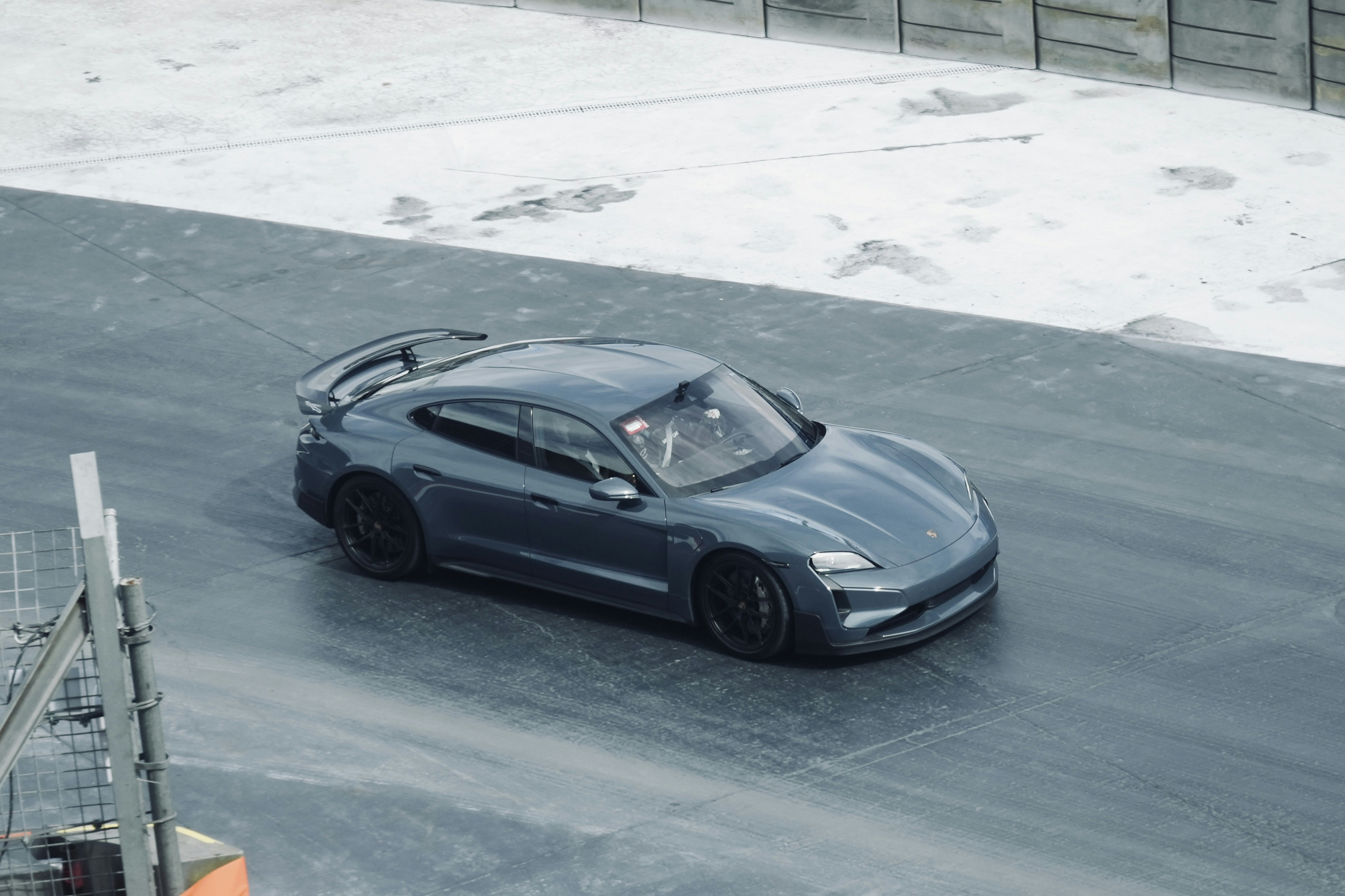 Un'auto sportiva blu che guida su una pista