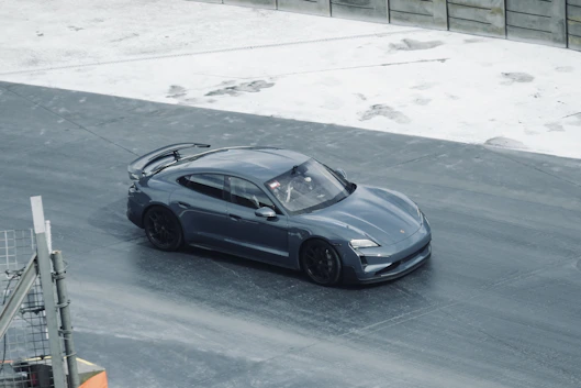A blue sports car driving on a track