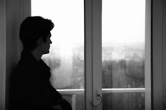 A person standing in front of a window