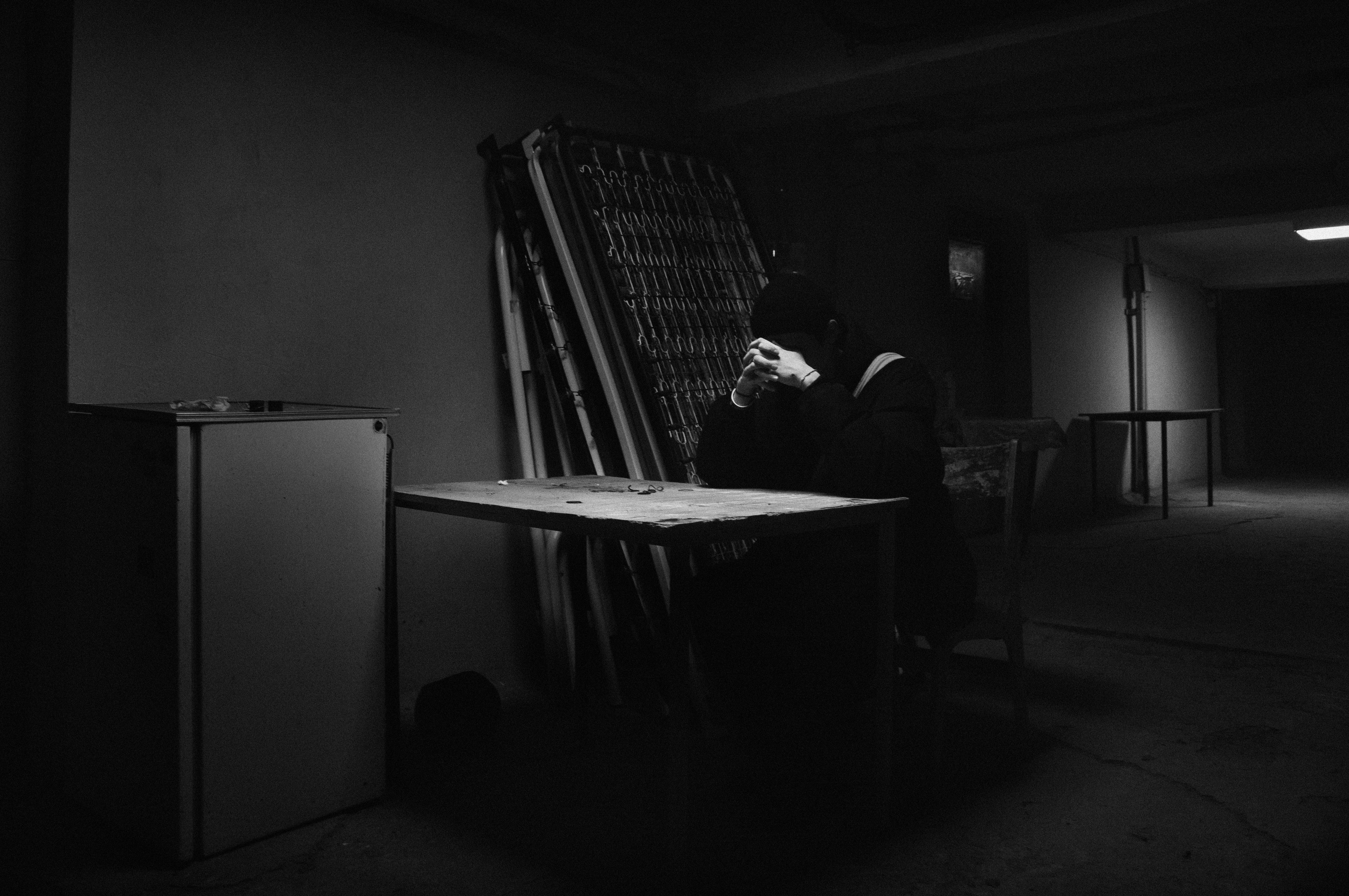 A man sitting at a table in a dark room