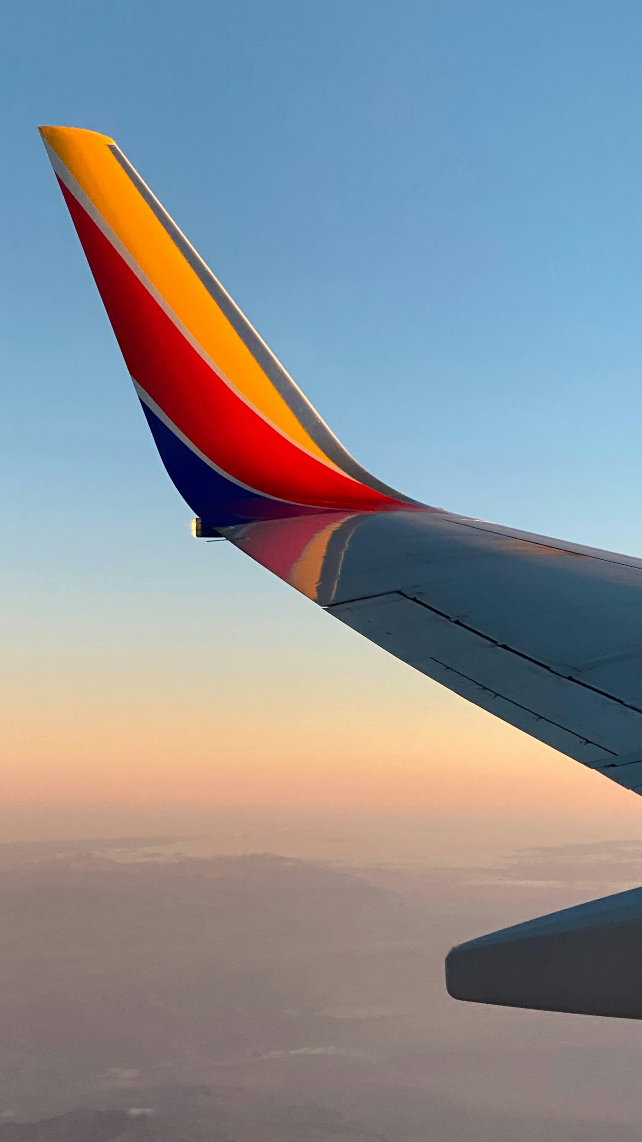 A view of the wing of an airplane in the sky