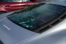 A silver car parked next to a red car