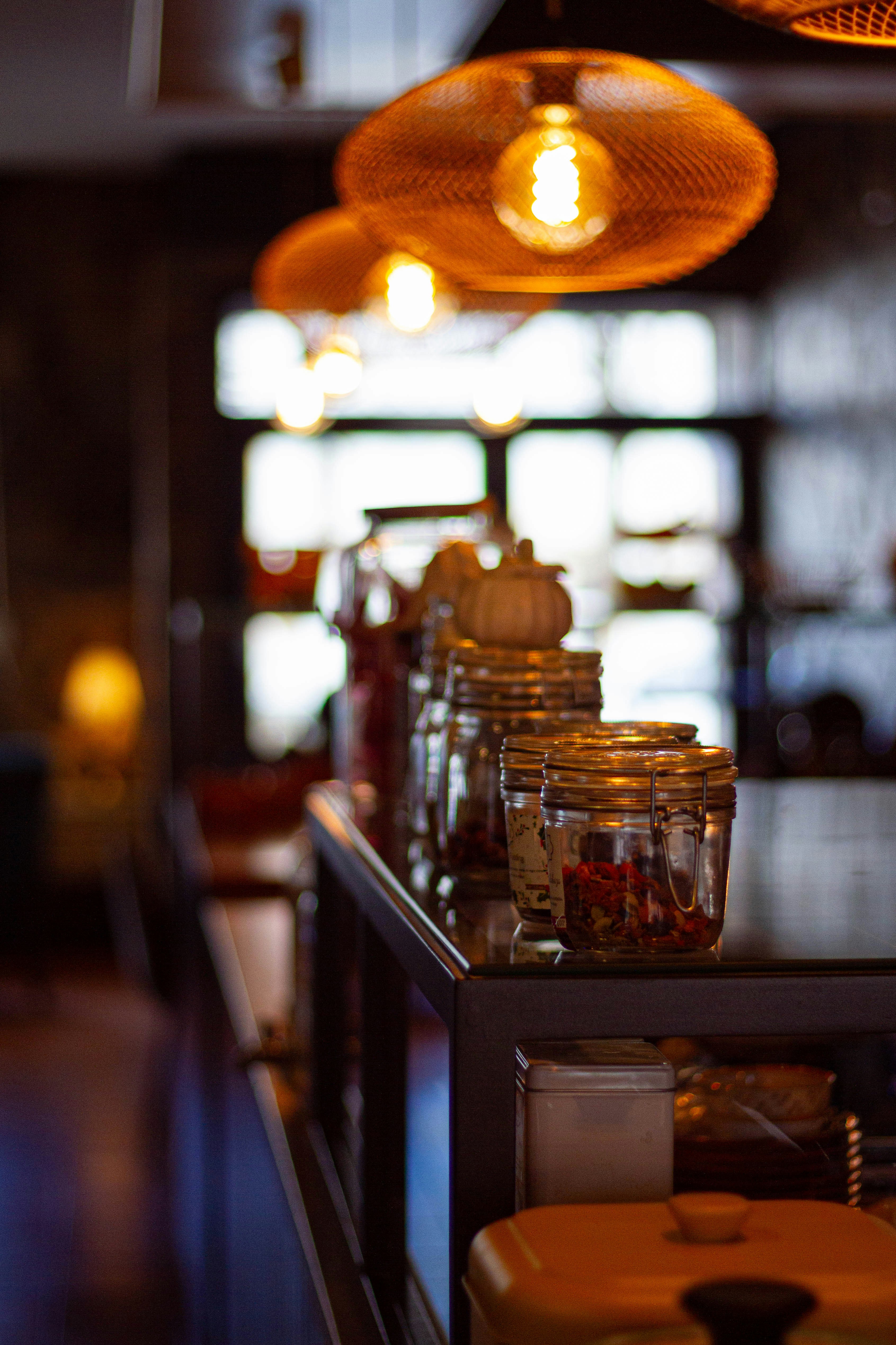 A row of jars sitting on top of a counter