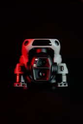 A red and white camera sitting on top of a table
