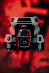 A close up of a camera with a red background