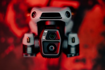 A close up of a camera with a red background