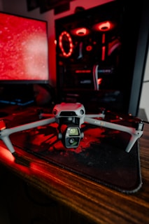 A computer desk with two monitors and a camera