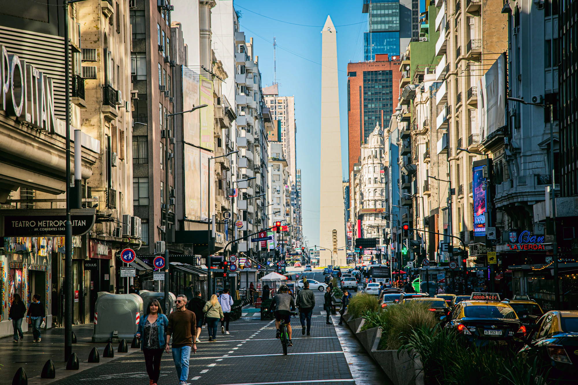 A city street filled with lots of tall buildings