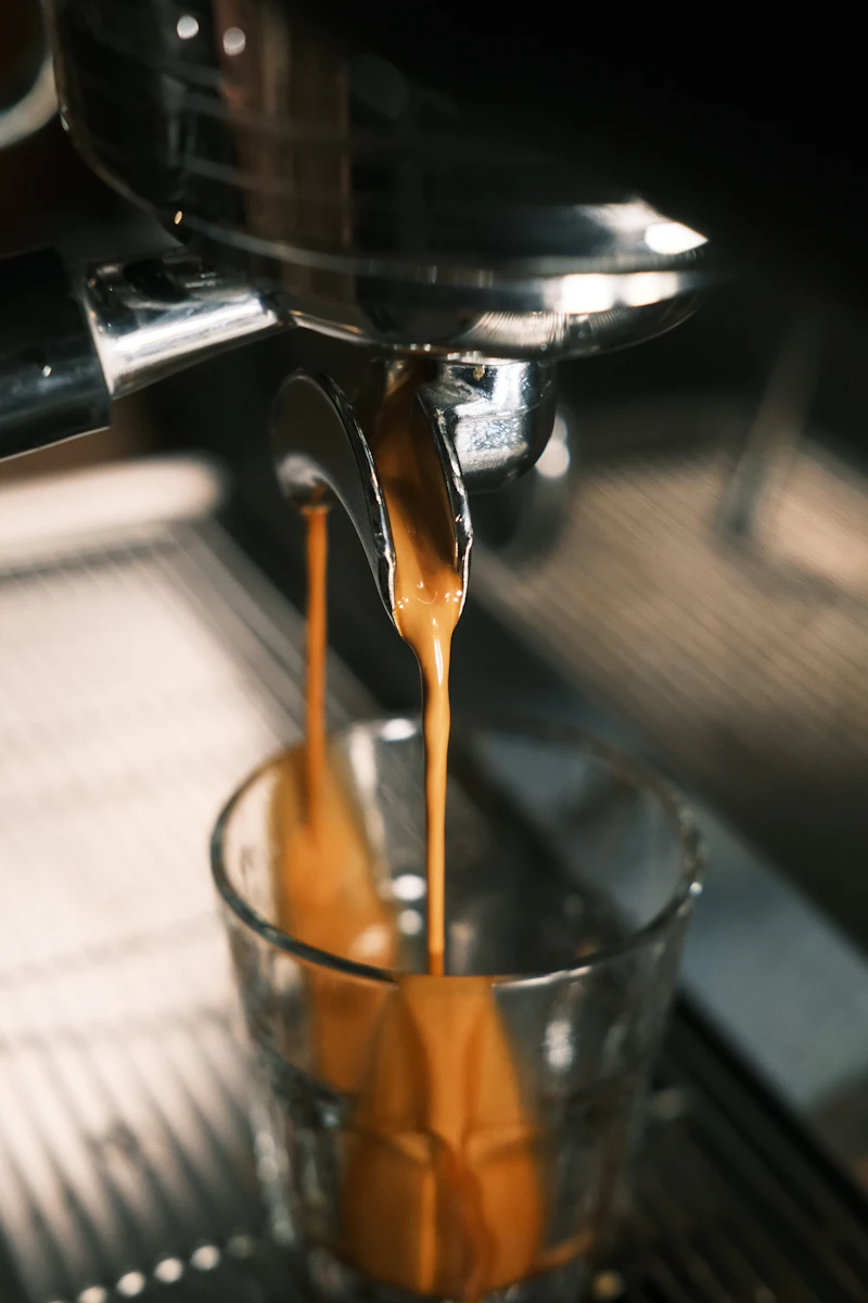 Professional barista pulls espresso shot over scale