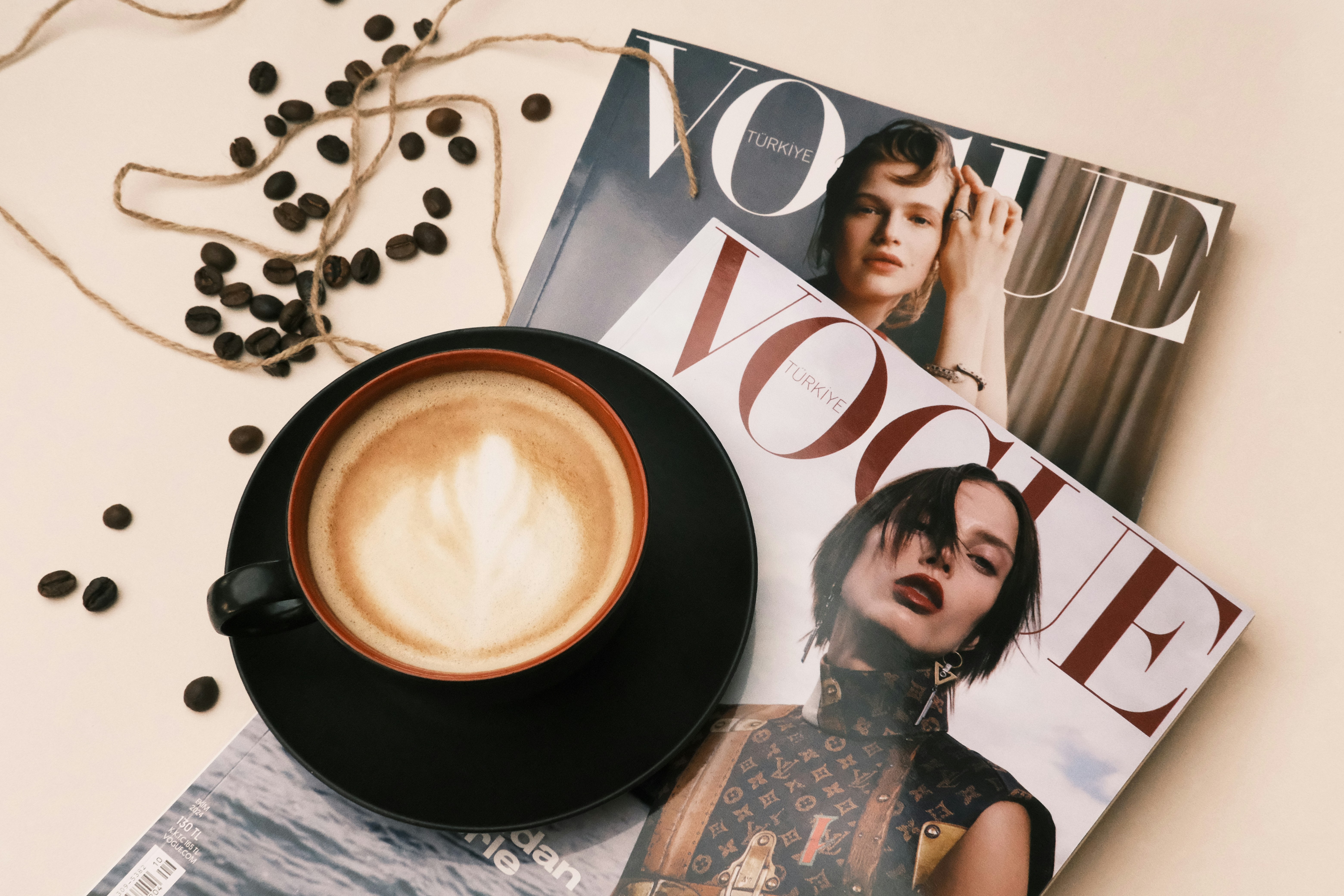 A cup of coffee sitting on top of a magazine