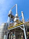 A factory with a lot of pipes and tanks