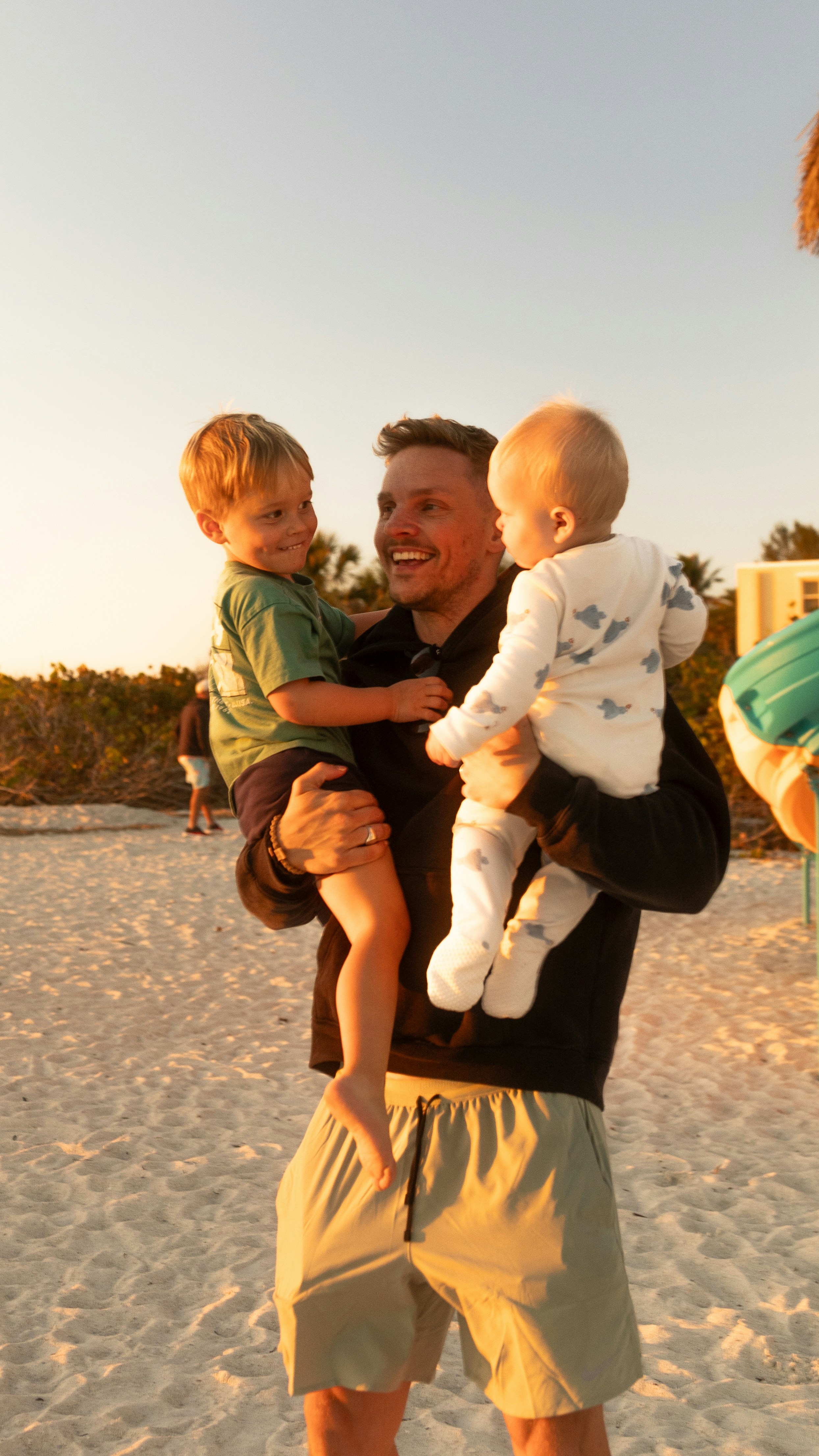 A man holding a child on the beach
