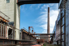 An industrial area with a factory and a bridge