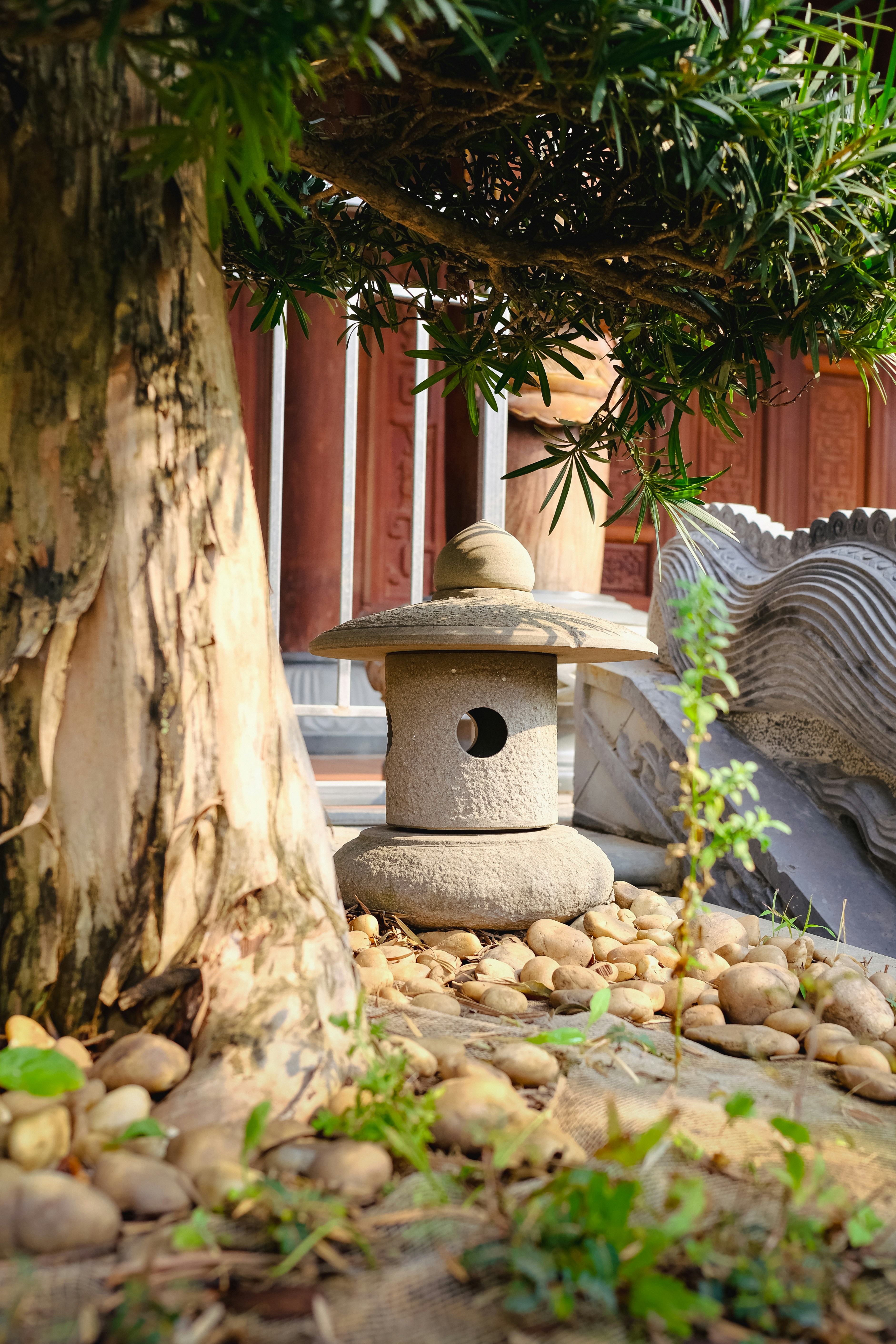 A bird house in the middle of a garden