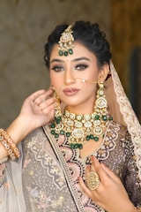 A woman wearing a bridal outfit and jewelry
