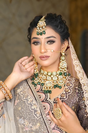 A woman wearing a bridal outfit and jewelry