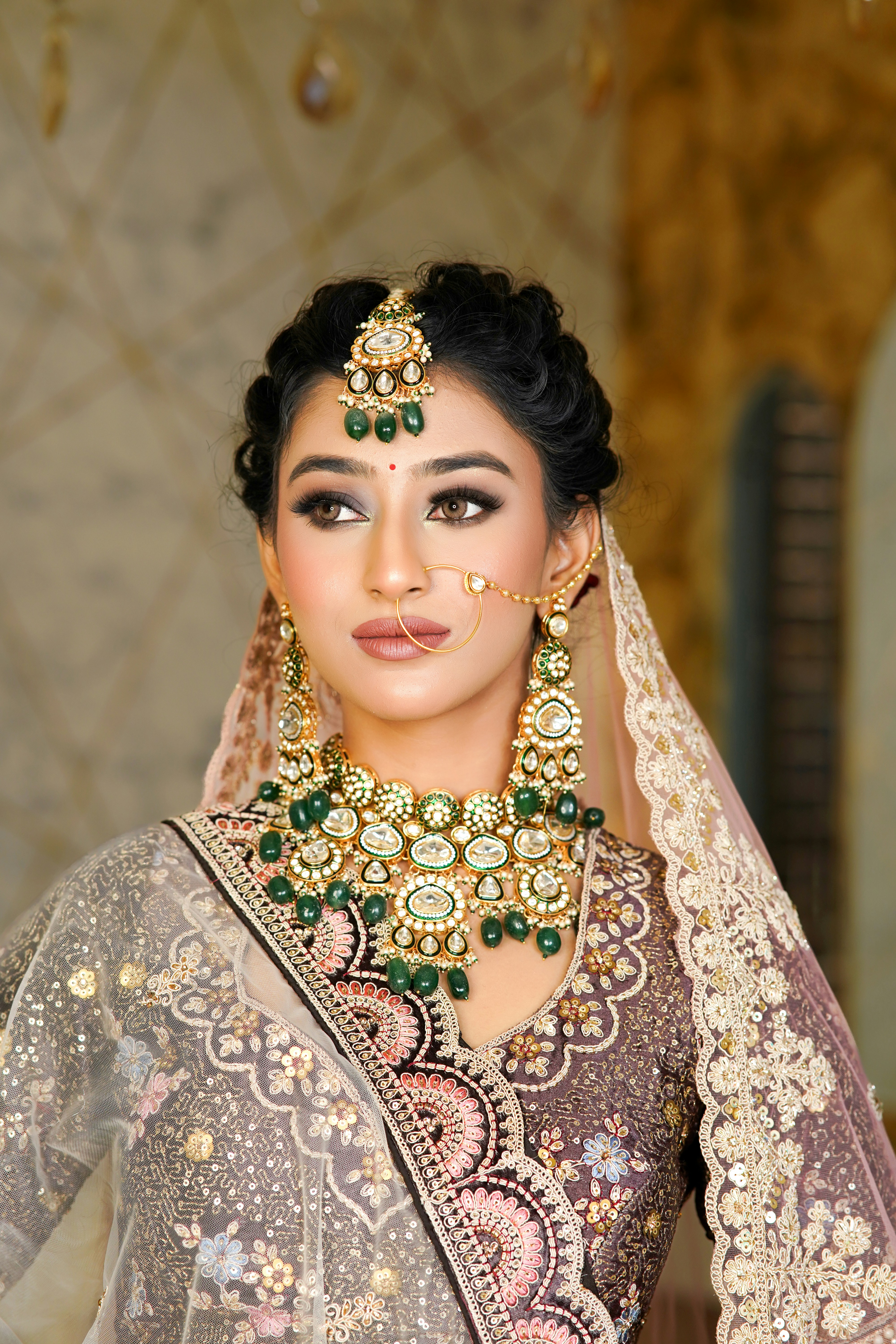 A woman wearing a bridal outfit and jewelry