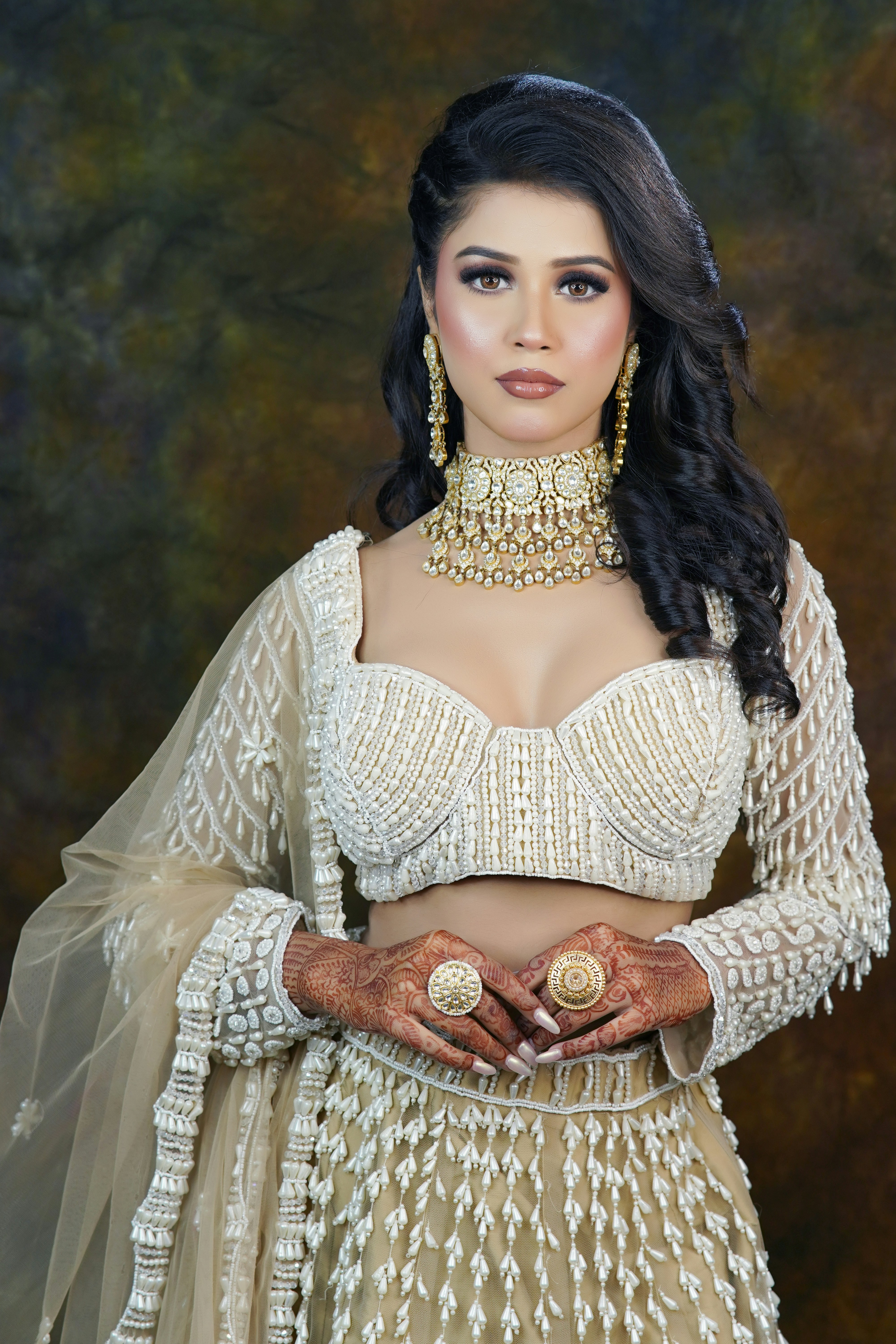 A woman wearing a white outfit and jewelry
