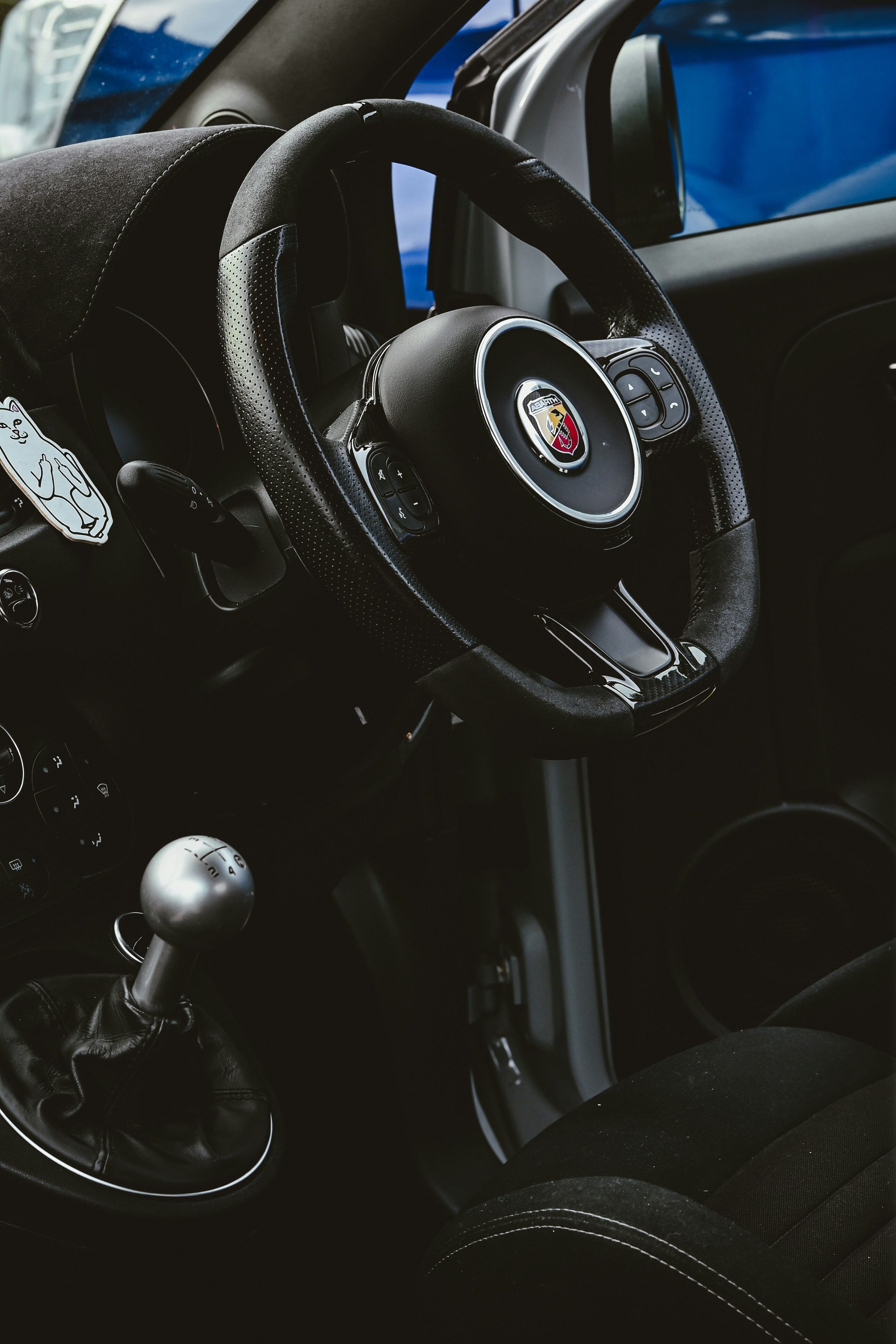 A person looking thoughtfully at their car's manual.