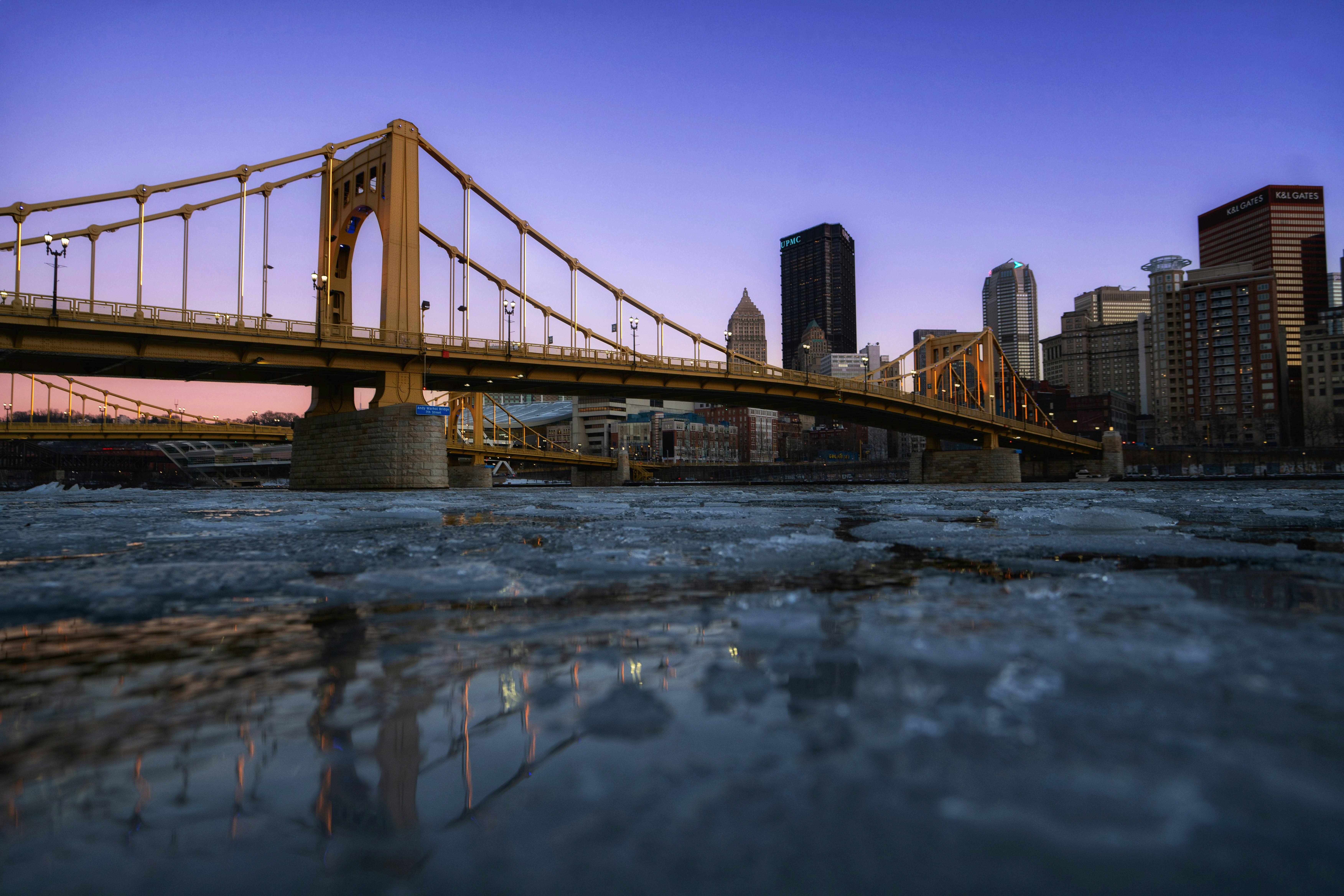 A bridge over a body of water with a city in the background