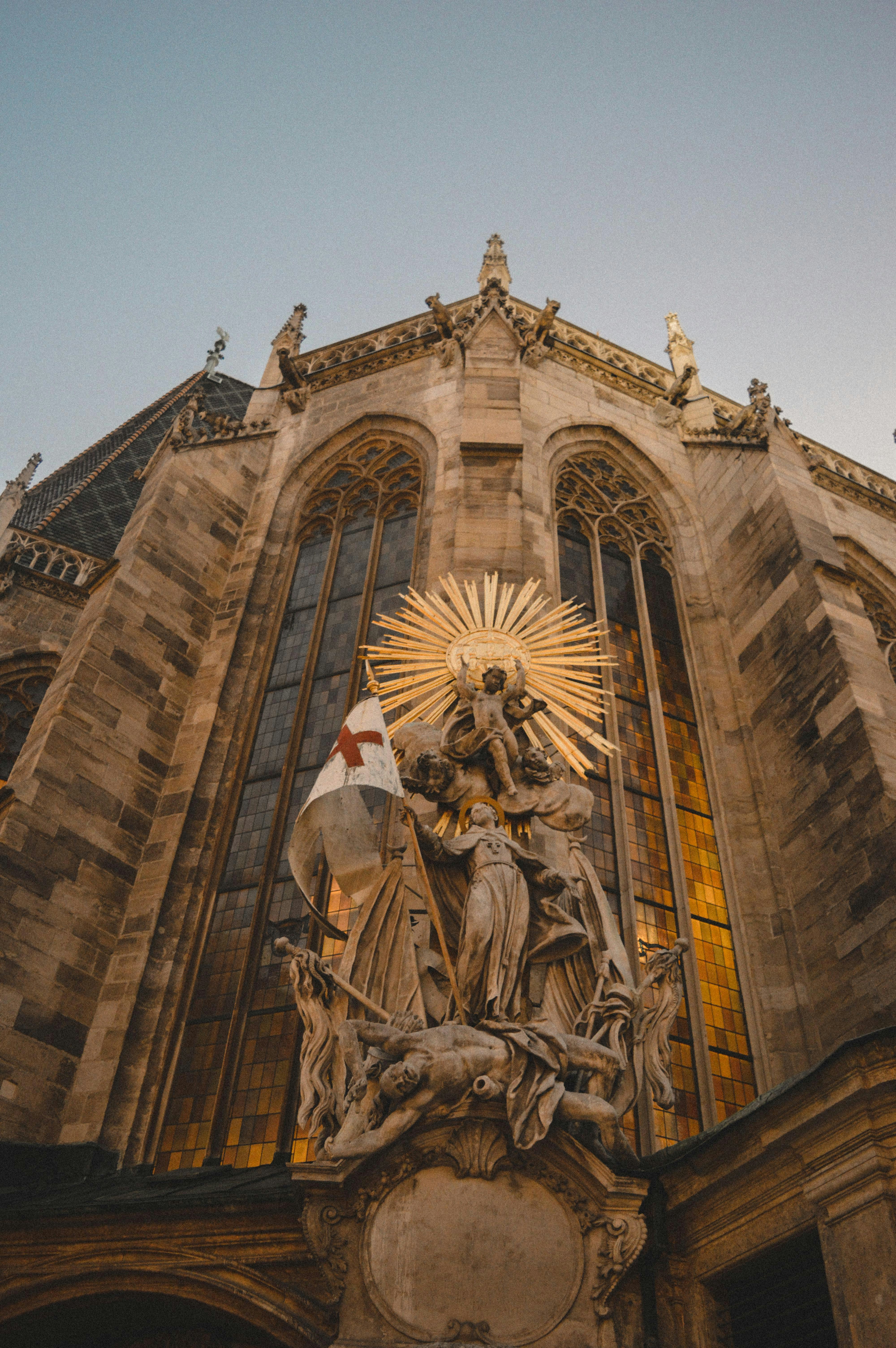 A statue of a person on a horse in front of a building