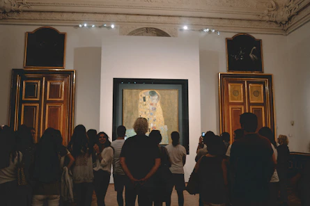 A group of people standing in front of a painting
