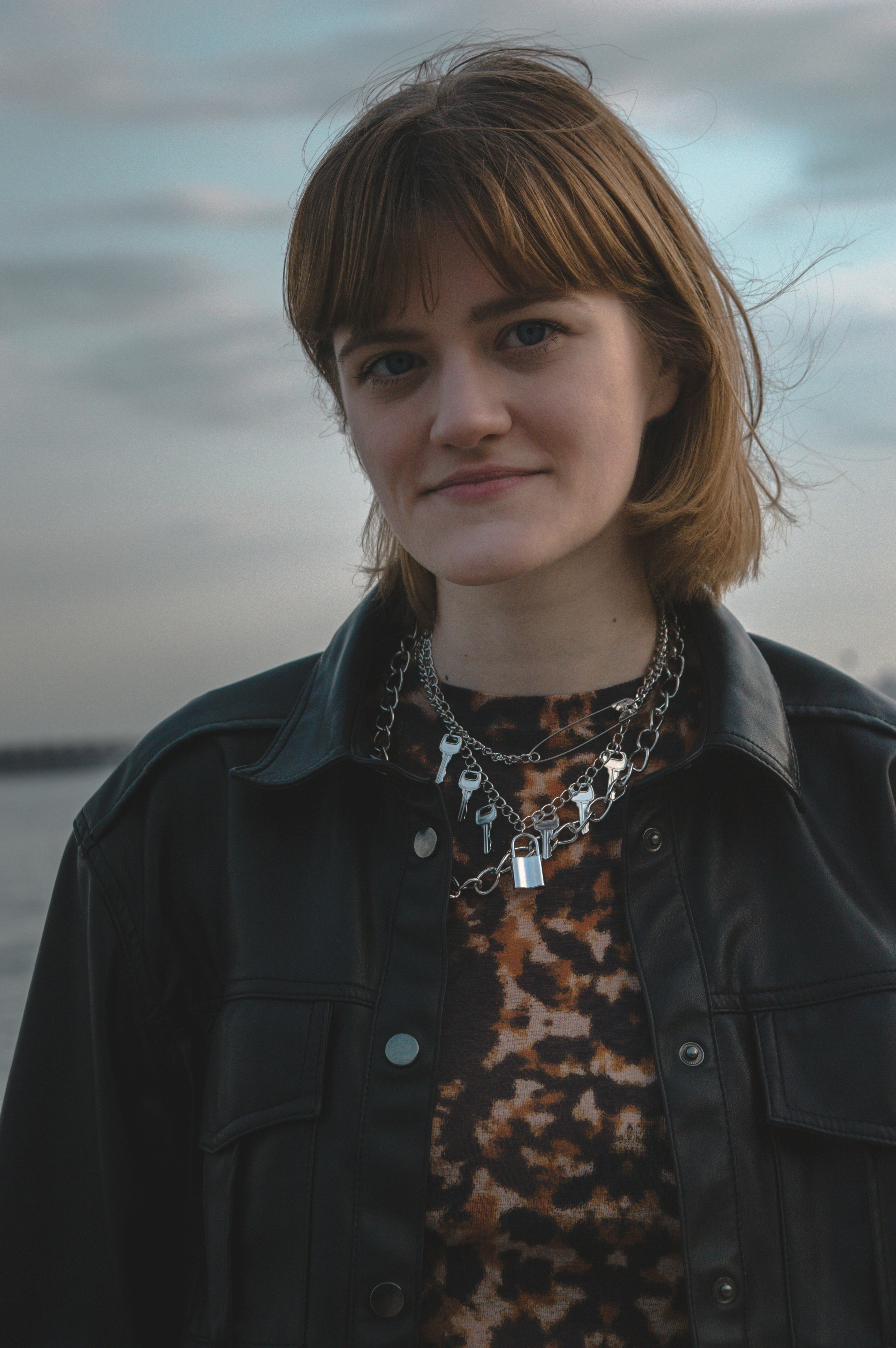 A woman standing in front of a body of water