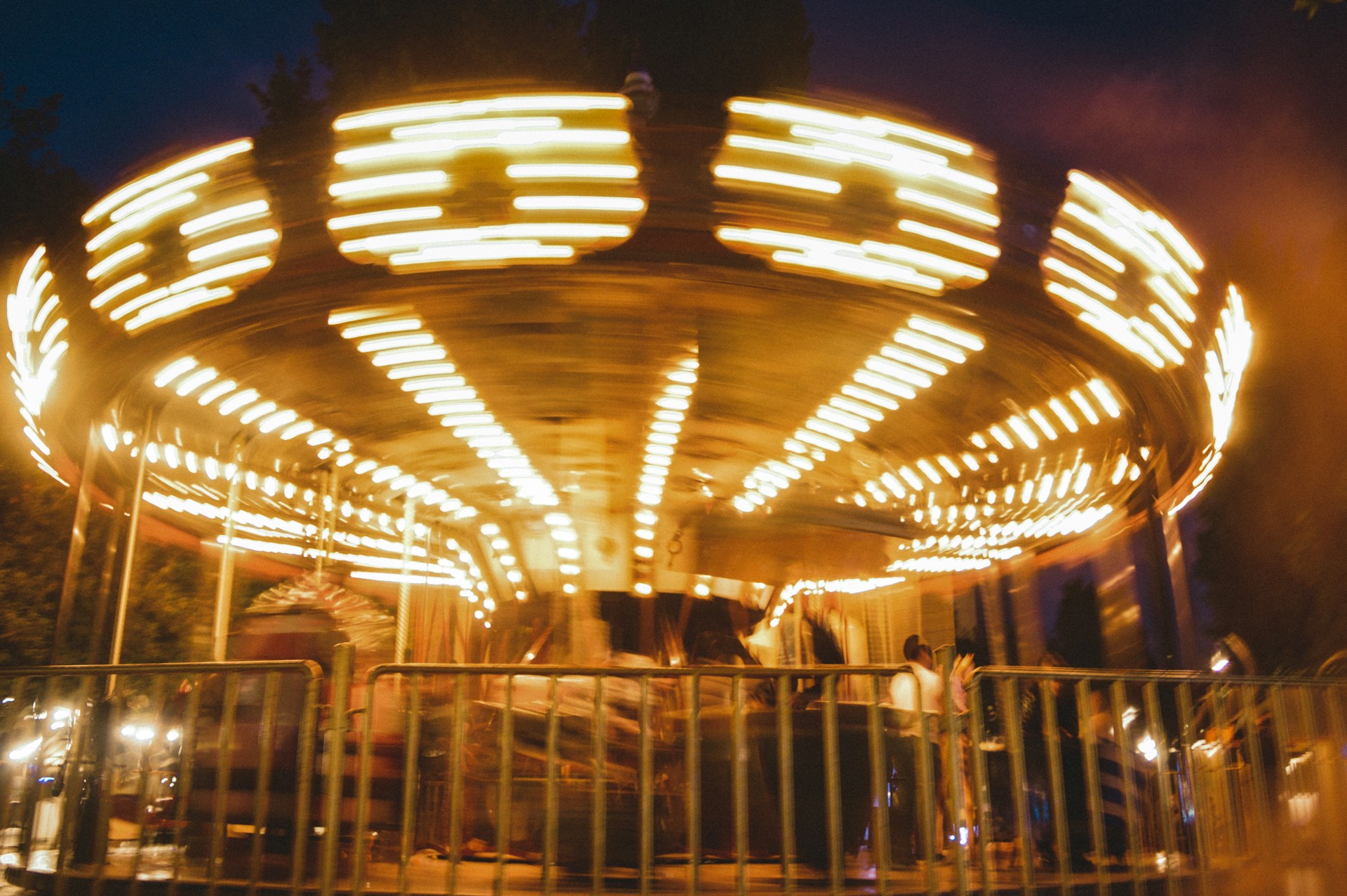A merry go round at night with people on it
