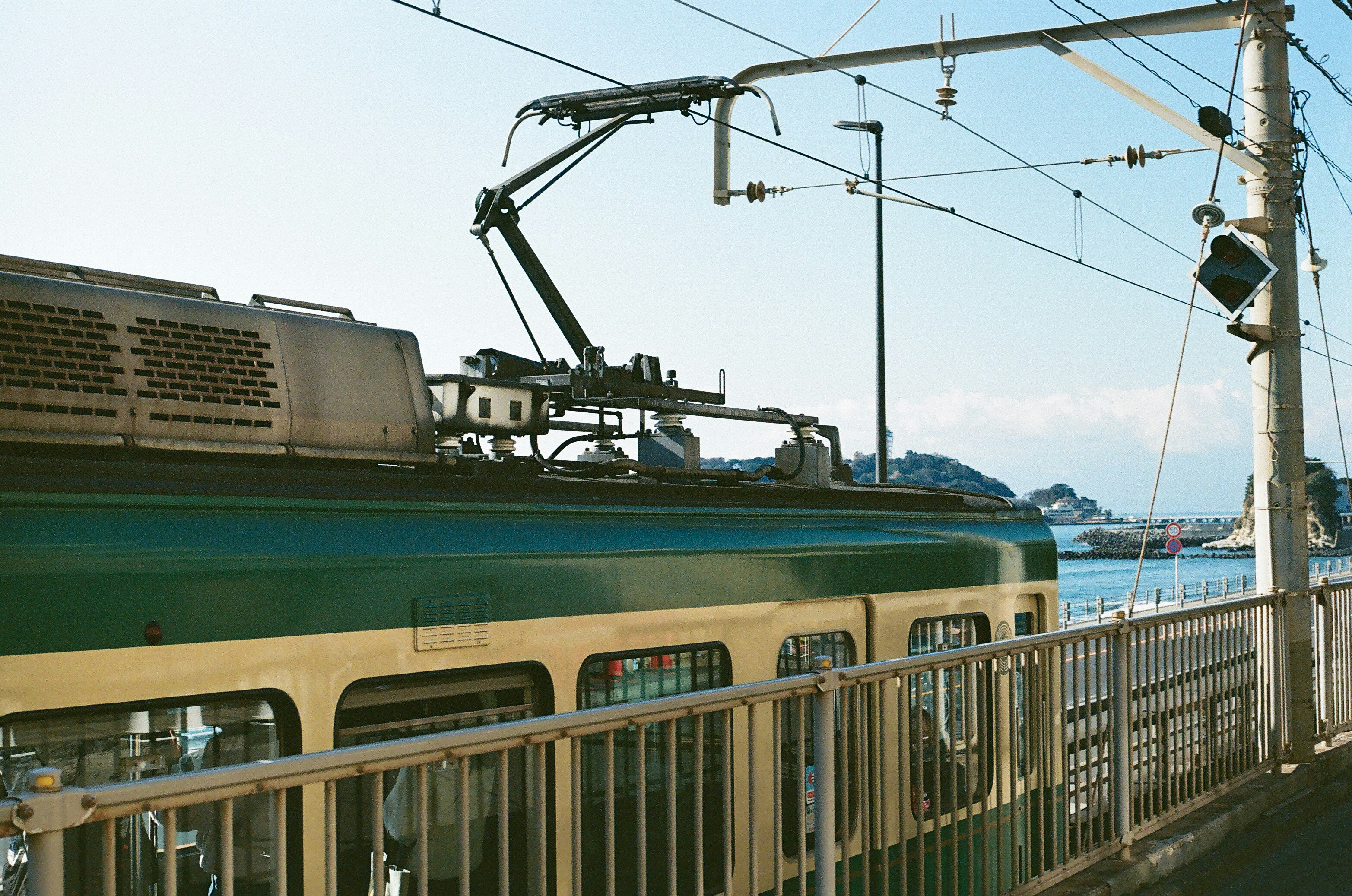 A train traveling down train tracks next to a body of water