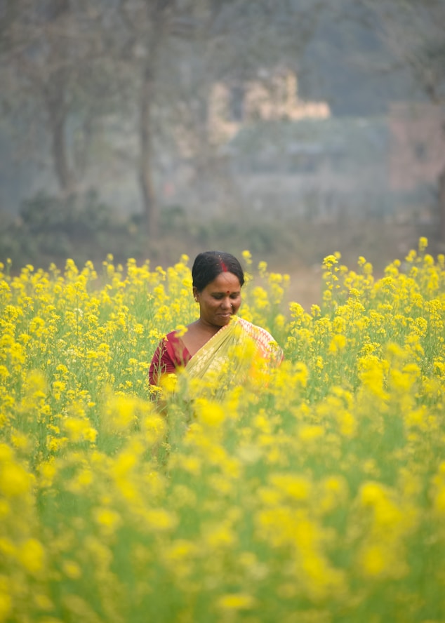 A woman standing in a field of yellow flowers